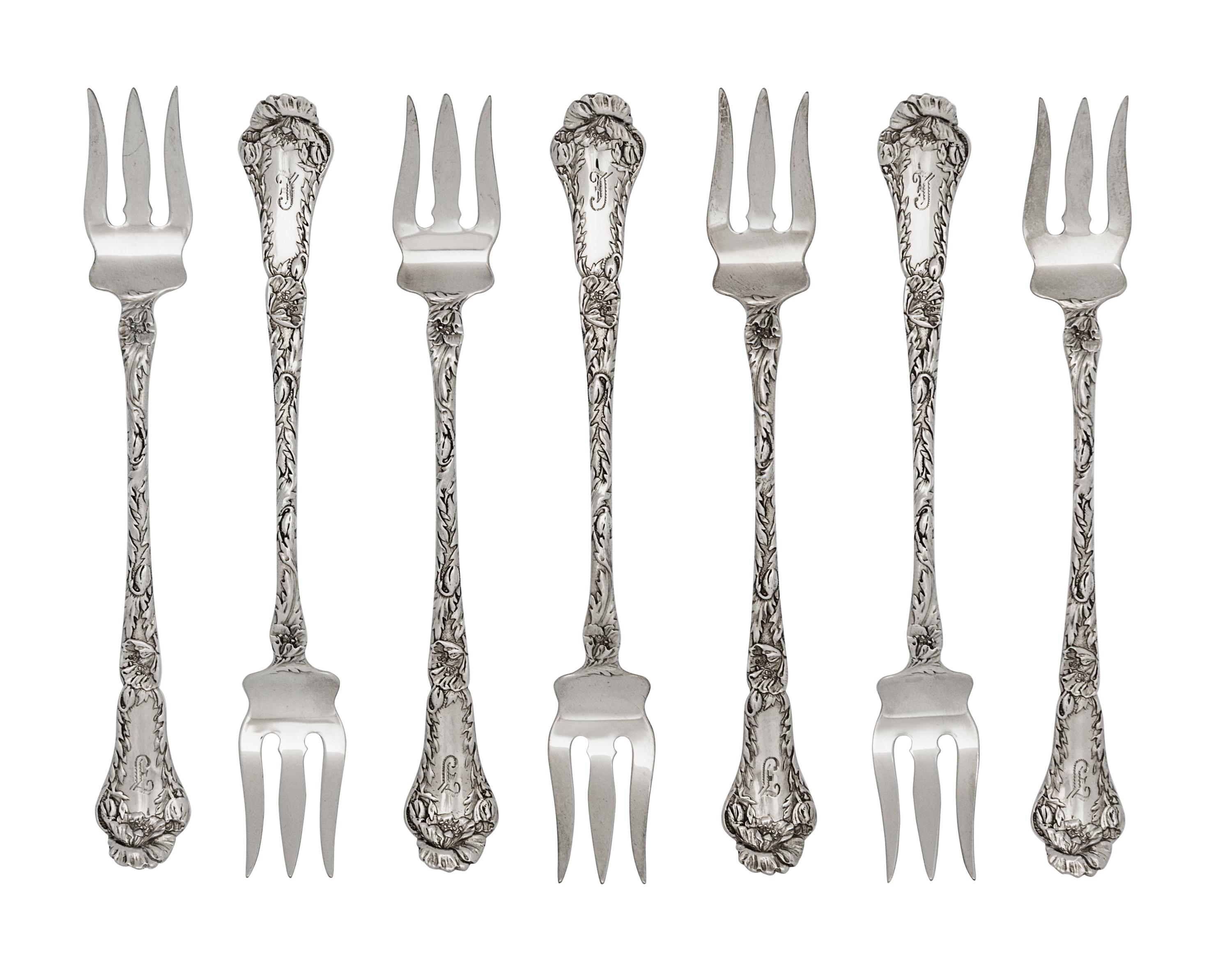A Set of Twelve American Silver Cocktail Forks, Gorham Mfg. Co., Providence, RI, each with a foliate decorated handle and shaft.