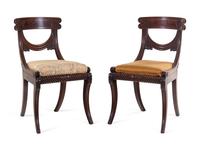 A Pair of Late Regency Carved and Figured Mahogany Side Chairs