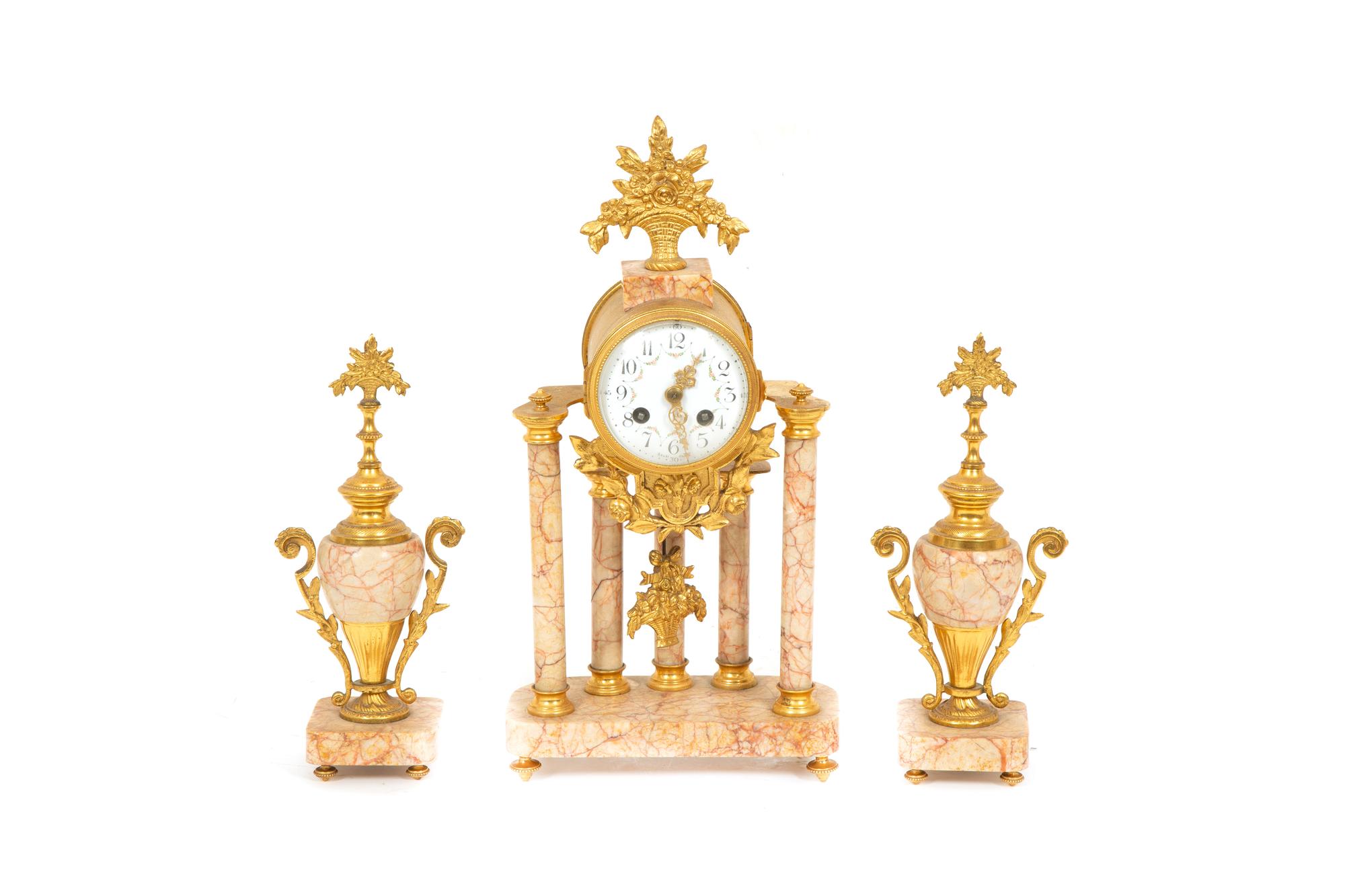 A French Gilt Bronze and Rouge Marble Clock Garniture