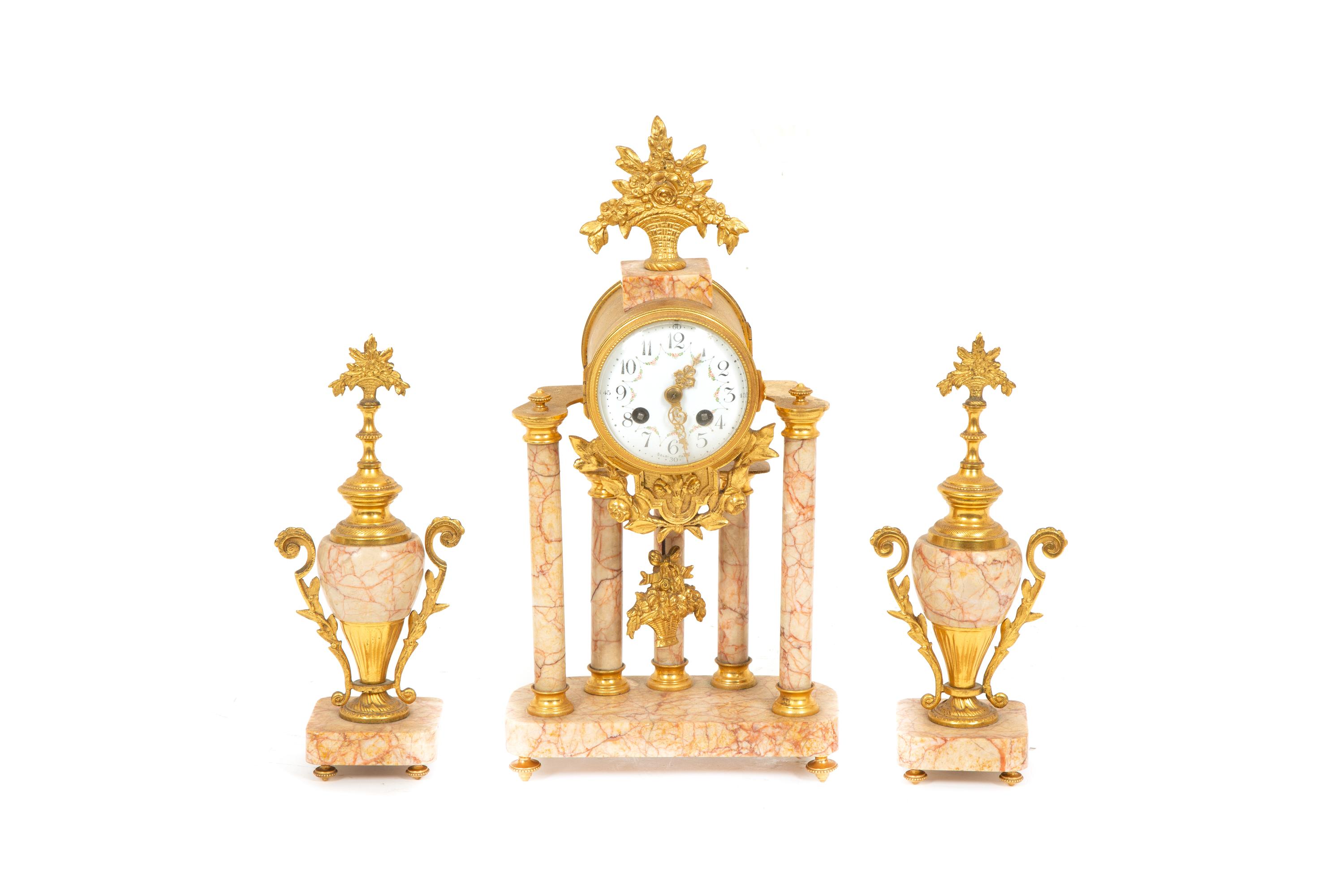 A French Gilt Bronze and Rouge Marble Clock Garniture