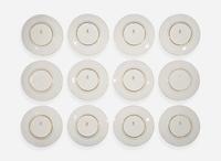 A set of twelve pate-sur-pate gilt and enameled porcelain luncheon plates, Minton, England, retailed by Tiffany & Co., New York, NY, date marks for 1928-1929