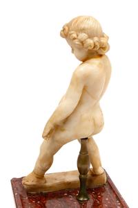A Continental Carved Marble Figure of a Putto on a Red Marble Base