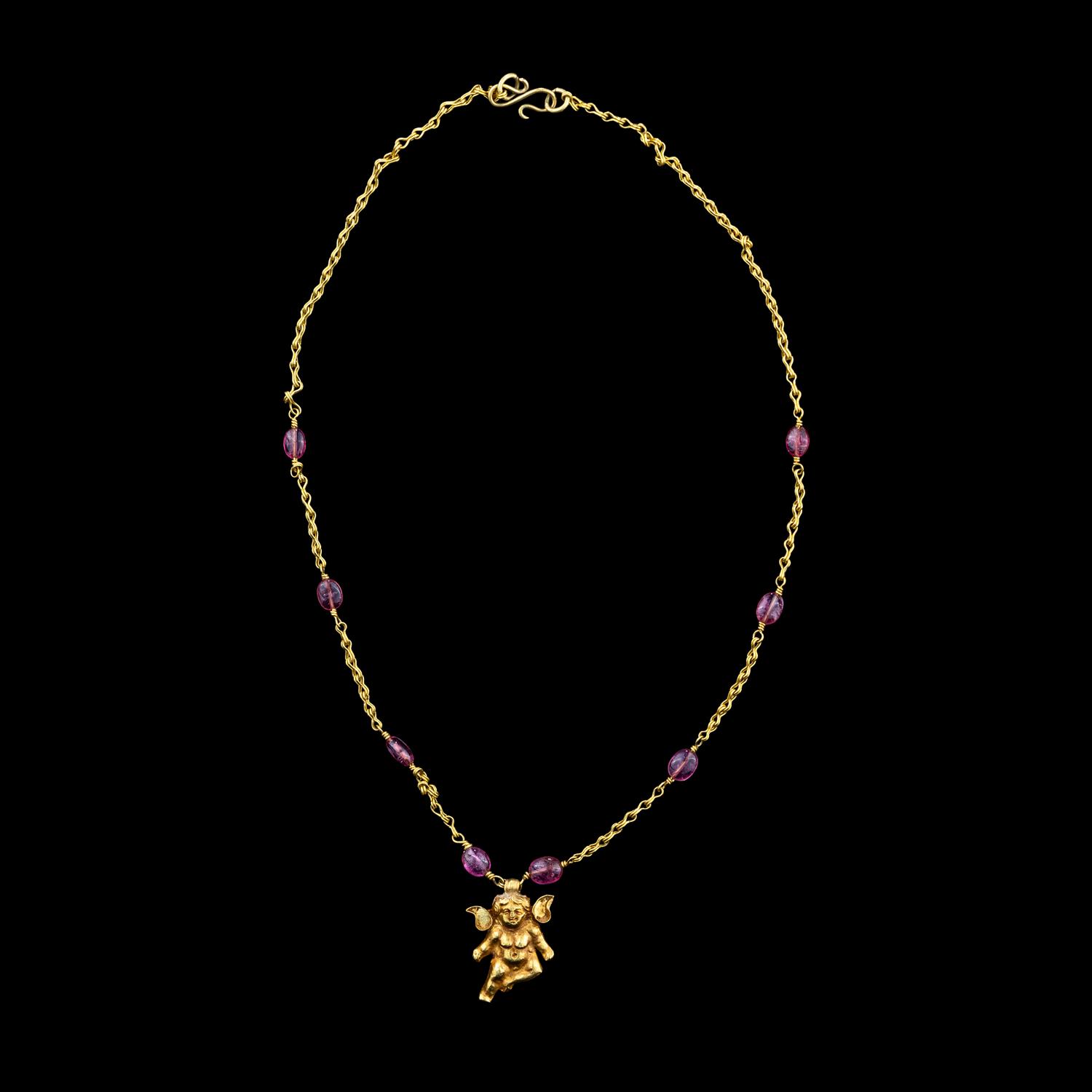 A Hellenistic Gold Eros Pendant — with a modern gold and pink spinel beads chain