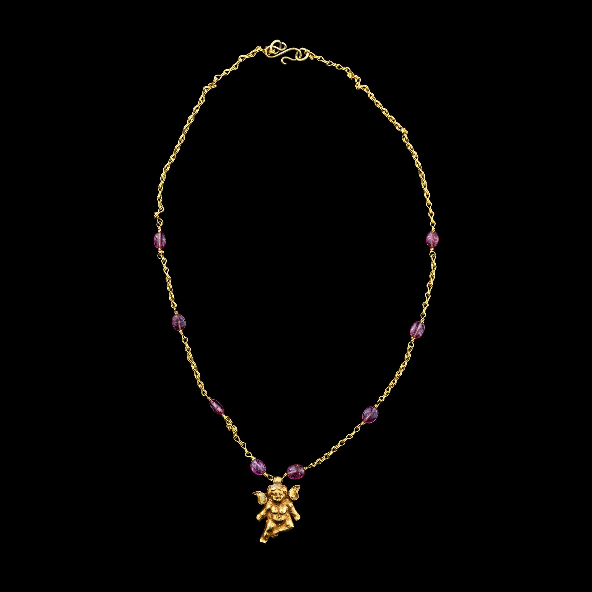 A Hellenistic Gold Eros Pendant — with a modern gold and pink spinel beads chain