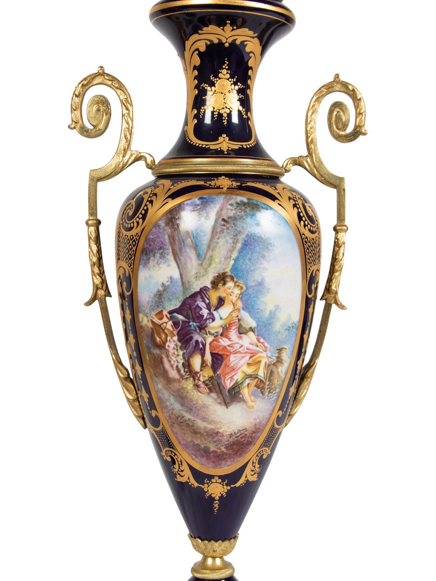 A Pair of Sèvres Style Gilt Metal Mounted Porcelain Covered Urns