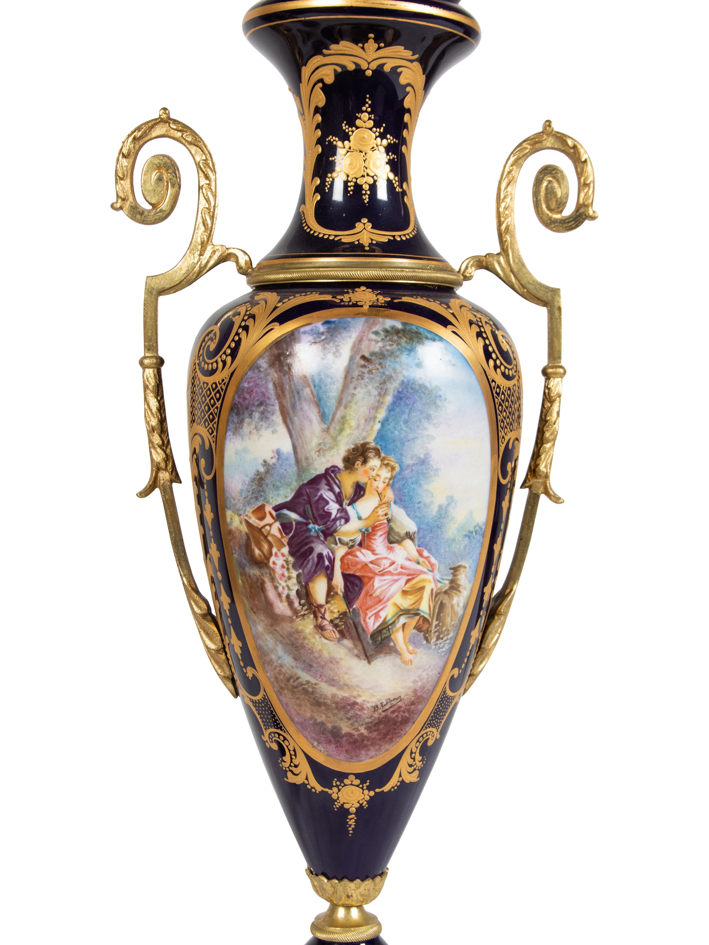 A Pair of Sèvres Style Gilt Metal Mounted Porcelain Covered Urns