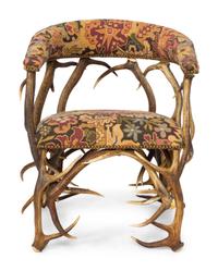 A Tapestry Upholstered Elk Antler Club Chair