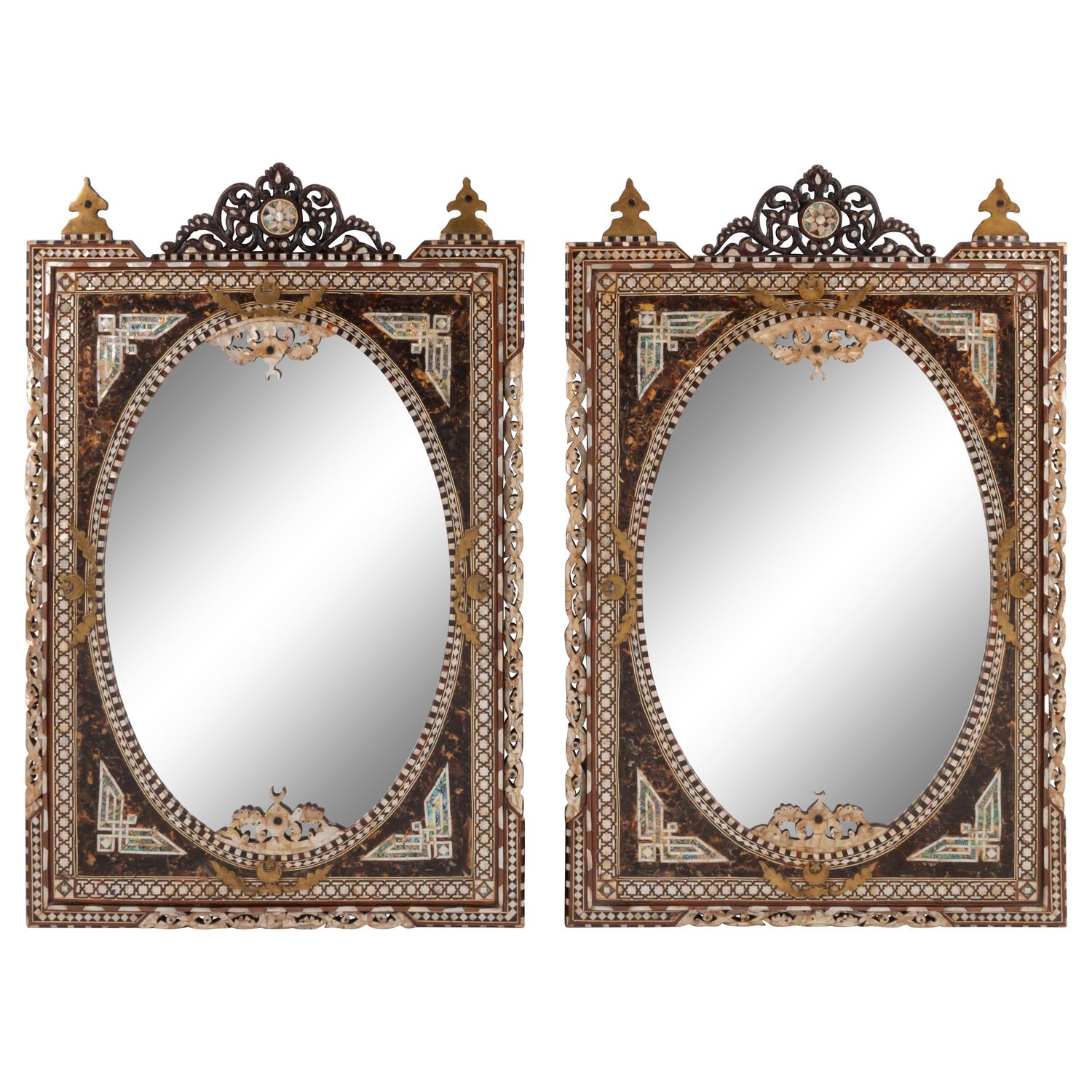 A Pair of Iberian Marquetry Oval Mirrors