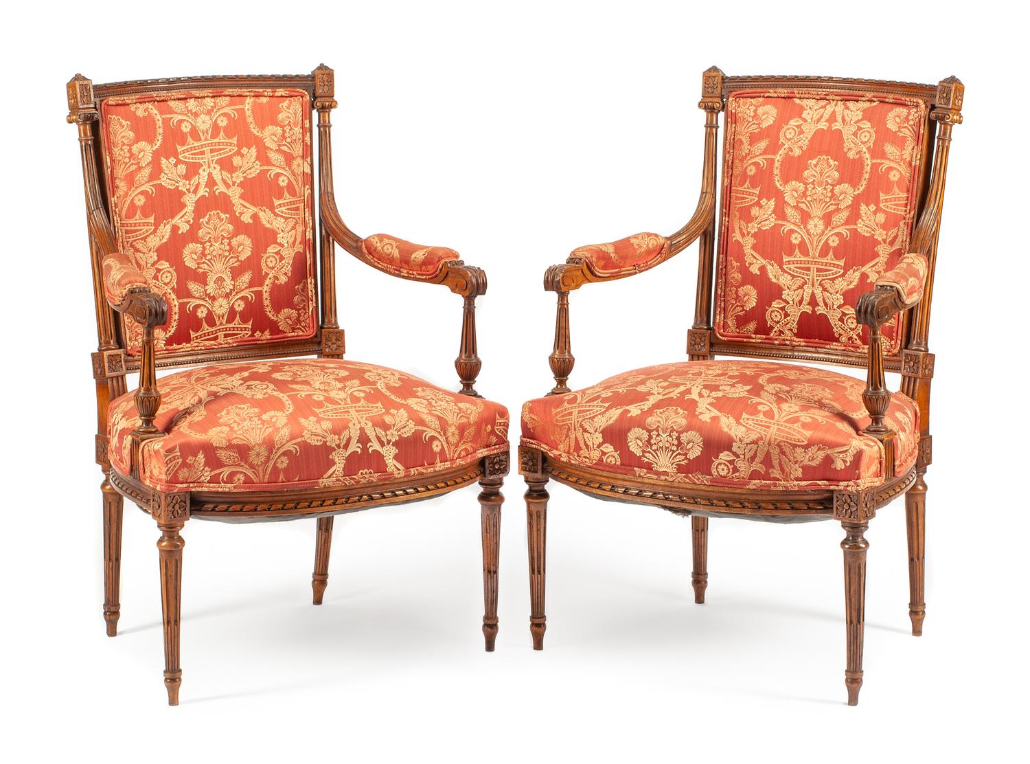 A Pair of Louis XVI Style Walnut Fauteuils Height 38 inches.