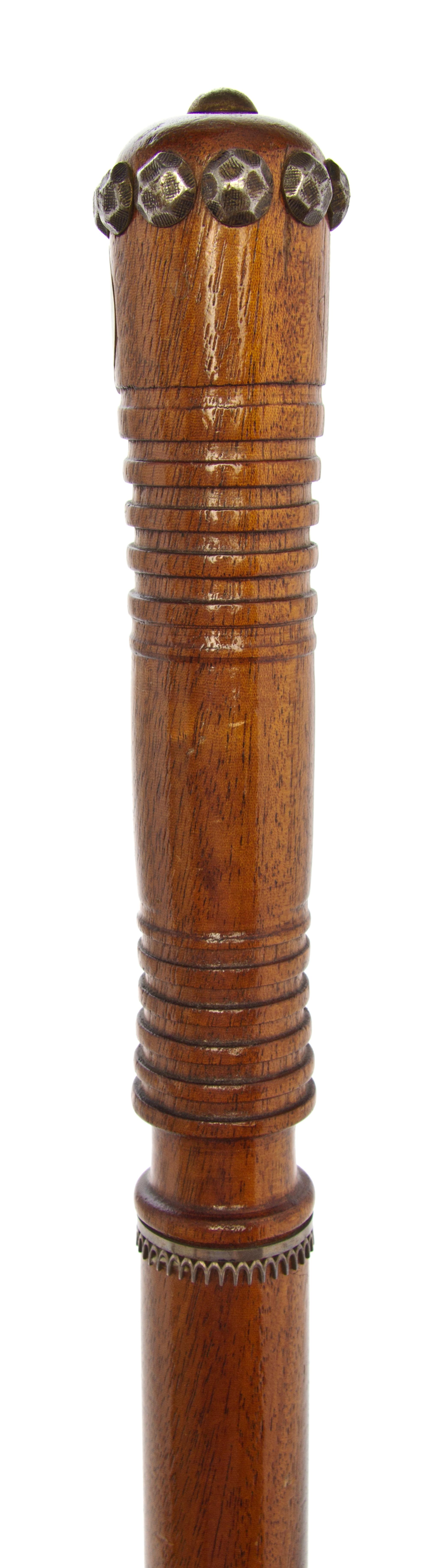 A Folk Art Mahogany Turned Wood Walking Stick, Length of handle 6 1/2 x length overall 35 3/4 inches.