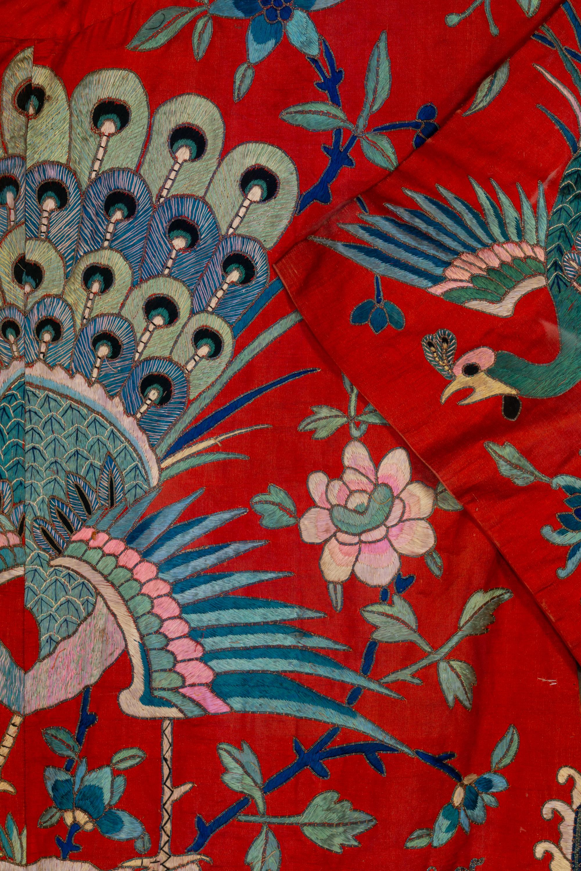 A Chinese Red Ground and Embroidered Silk 'Peacock' Robe