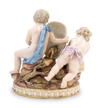 A Meissen Porcelain Group of Two Putti with a Theater Mask, Dog and Birdcage