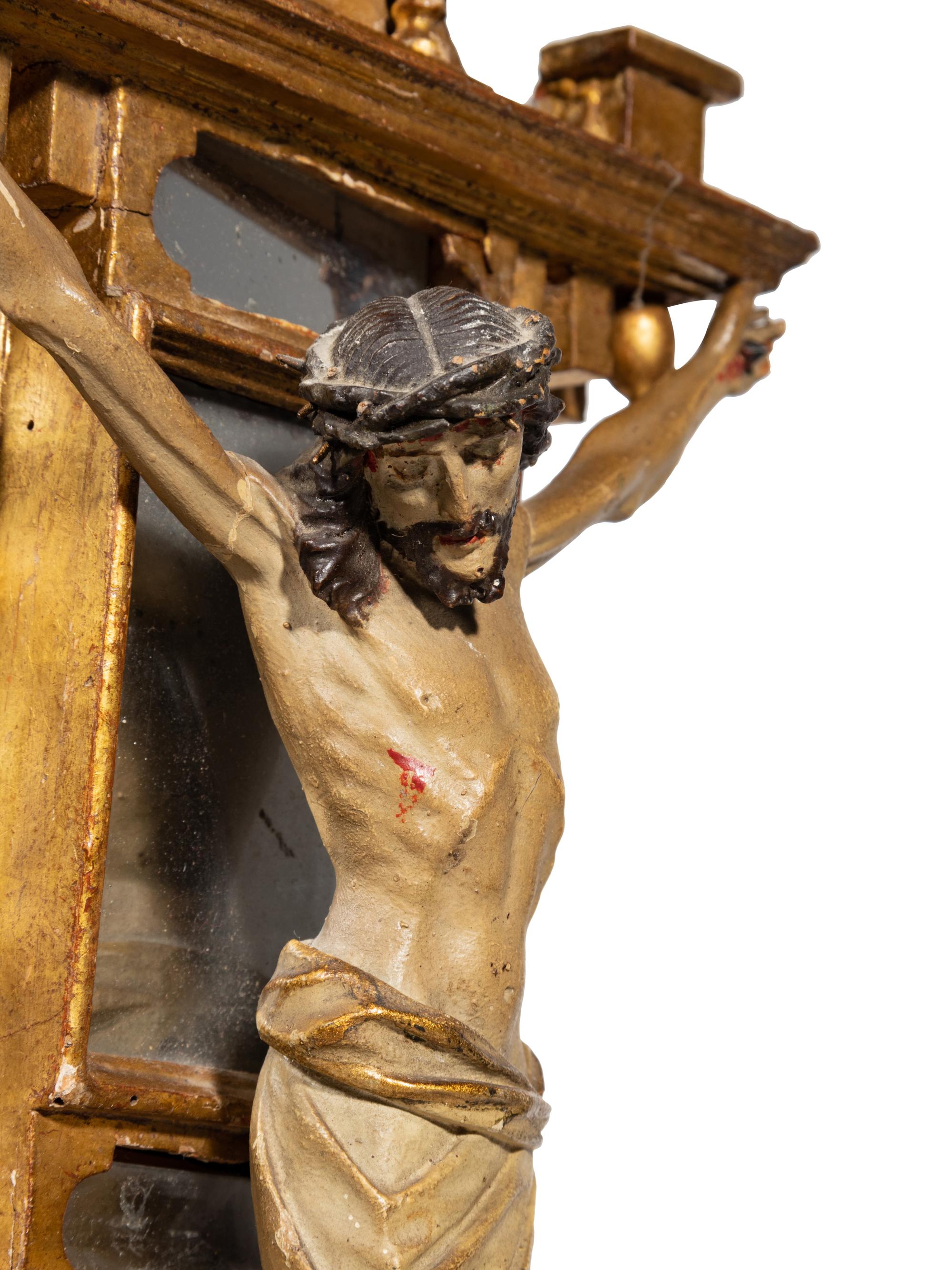A Continental Carved, Polychromed, Parcel Gilt and Mirrored Crucifix