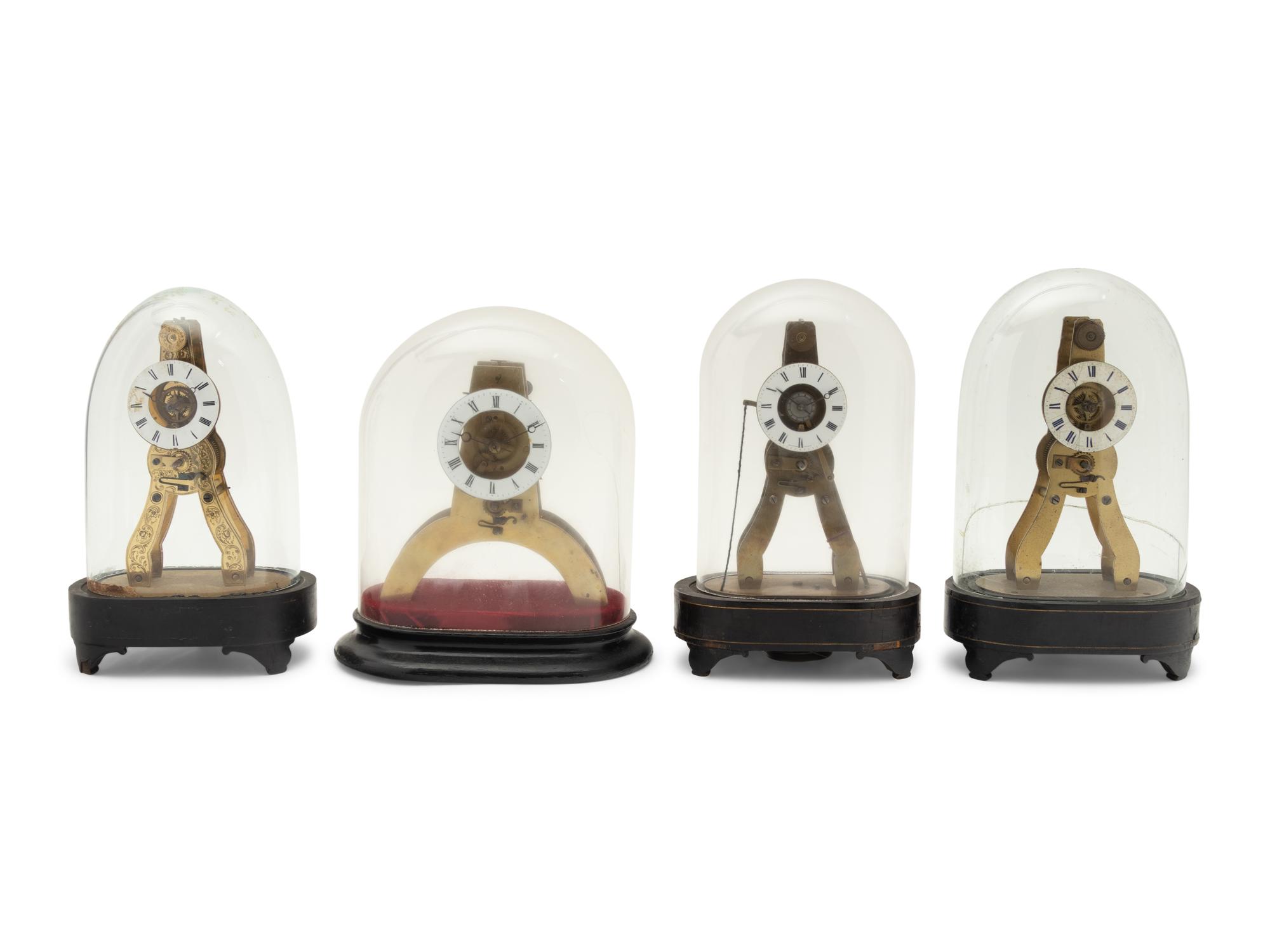 A Group of Four Brass Skeleton Clocks