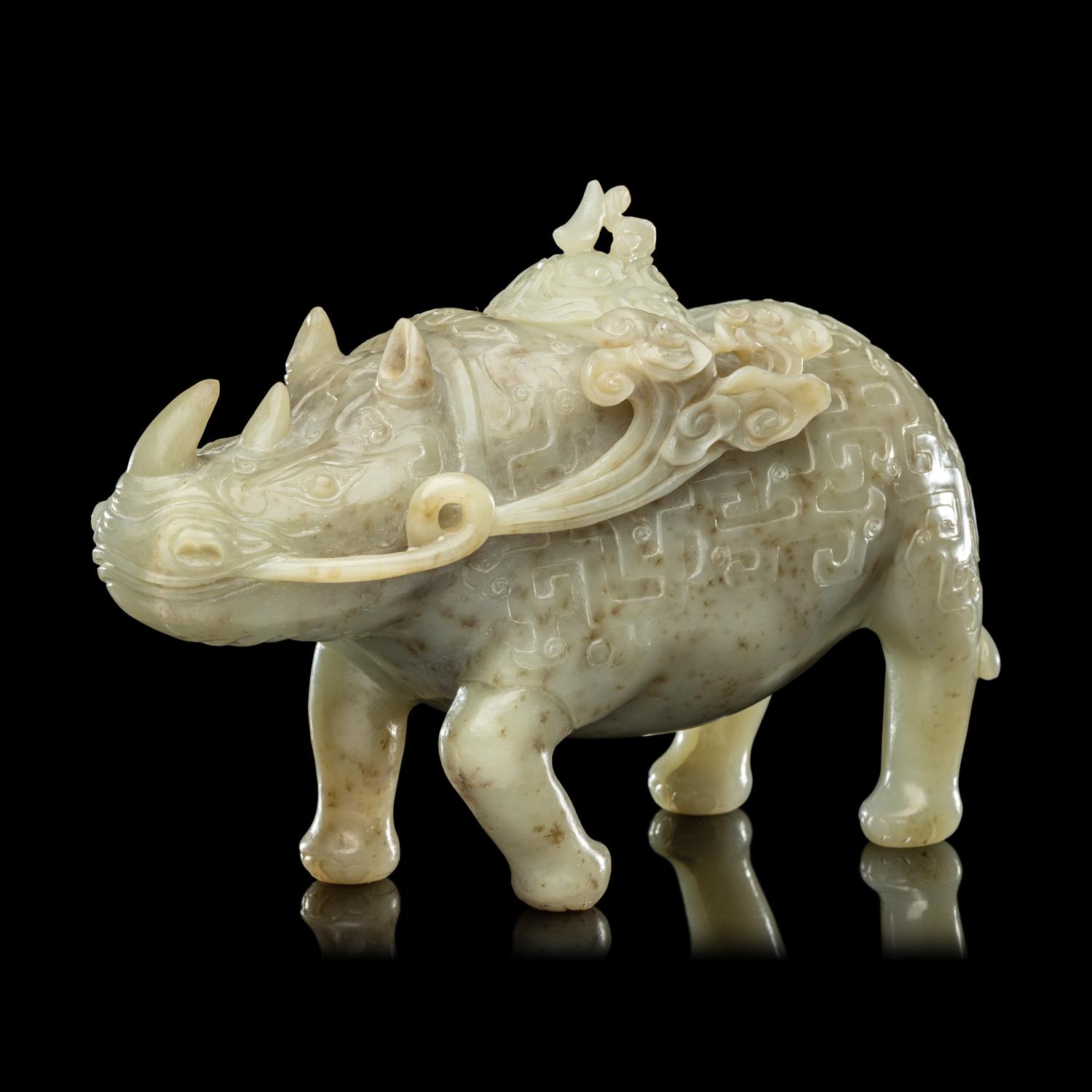 A Chinese Carved Celadon Jade Archaistic Rhinoceros-Form Covered Vessel, 20th Century 近代 青玉仿古犀尊