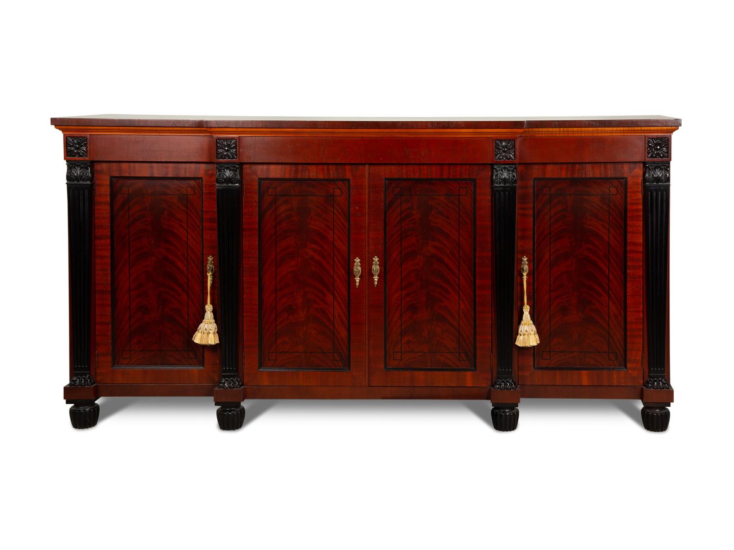 A Late Regency Style Figured Mahogany Sideboard with Carved Ebonized Pilasters