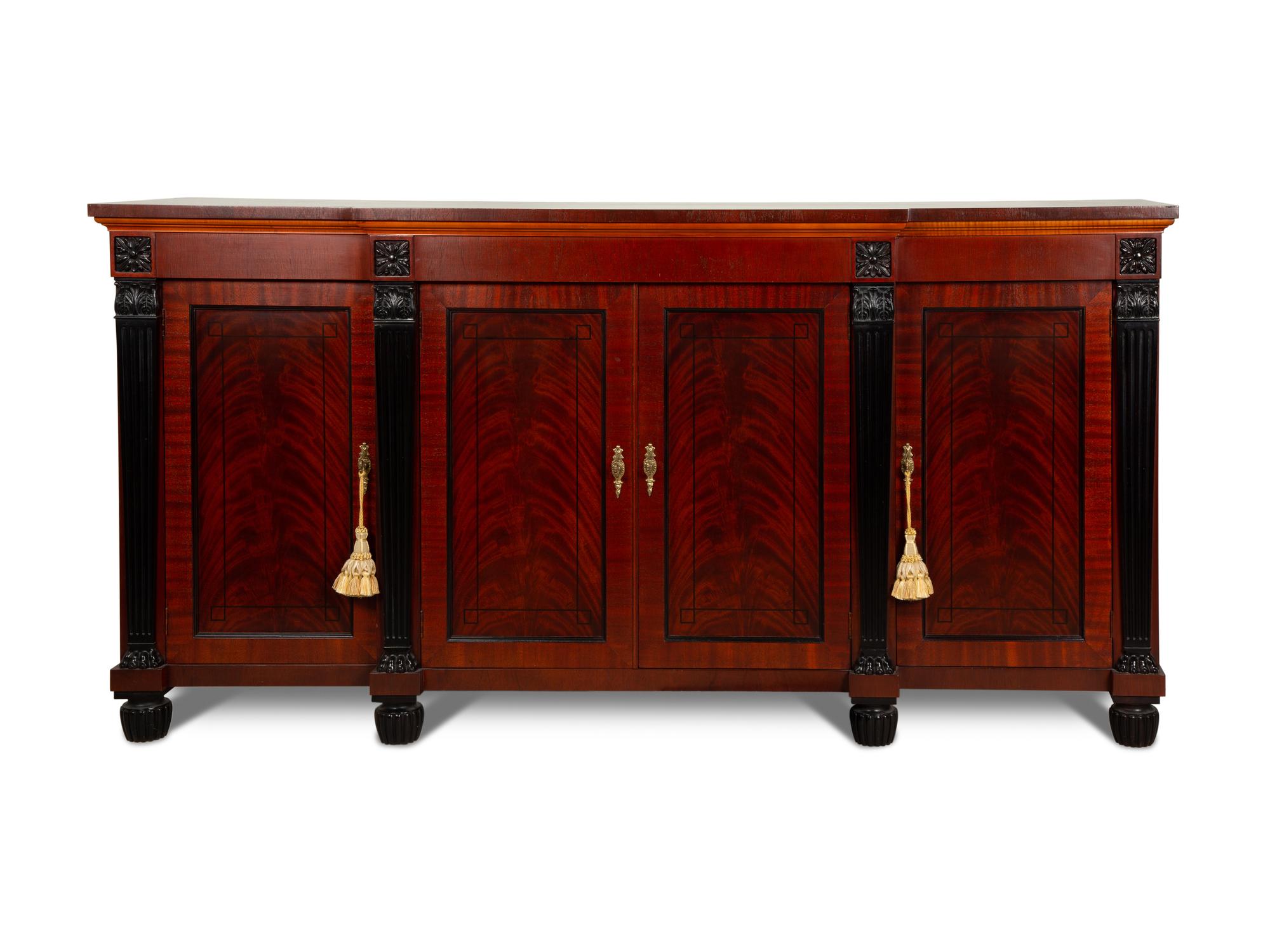 A Late Regency Style Figured Mahogany Sideboard with Carved Ebonized Pilasters