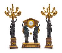 An Empire Gilt and Patinated Metal and Rouge Marble Three-Piece Figural Clock Garniture
