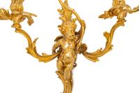 A Pair of Louis XV Style Gilt Bronze Figural Three-Light Sconces