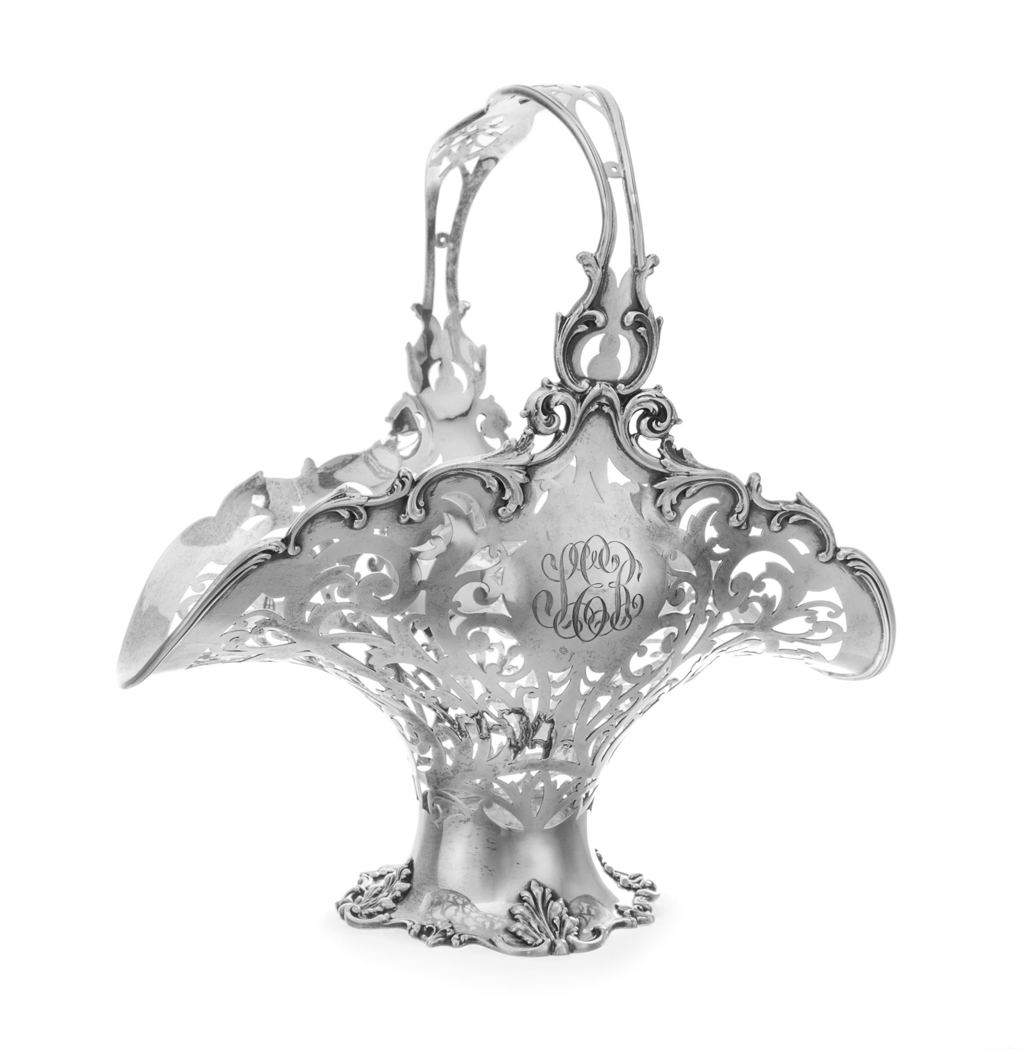 An American Silver Basket, Reed & Barton, Taunton, MA, having an openwork vine and volute decorated body and handle with an S-scroll de