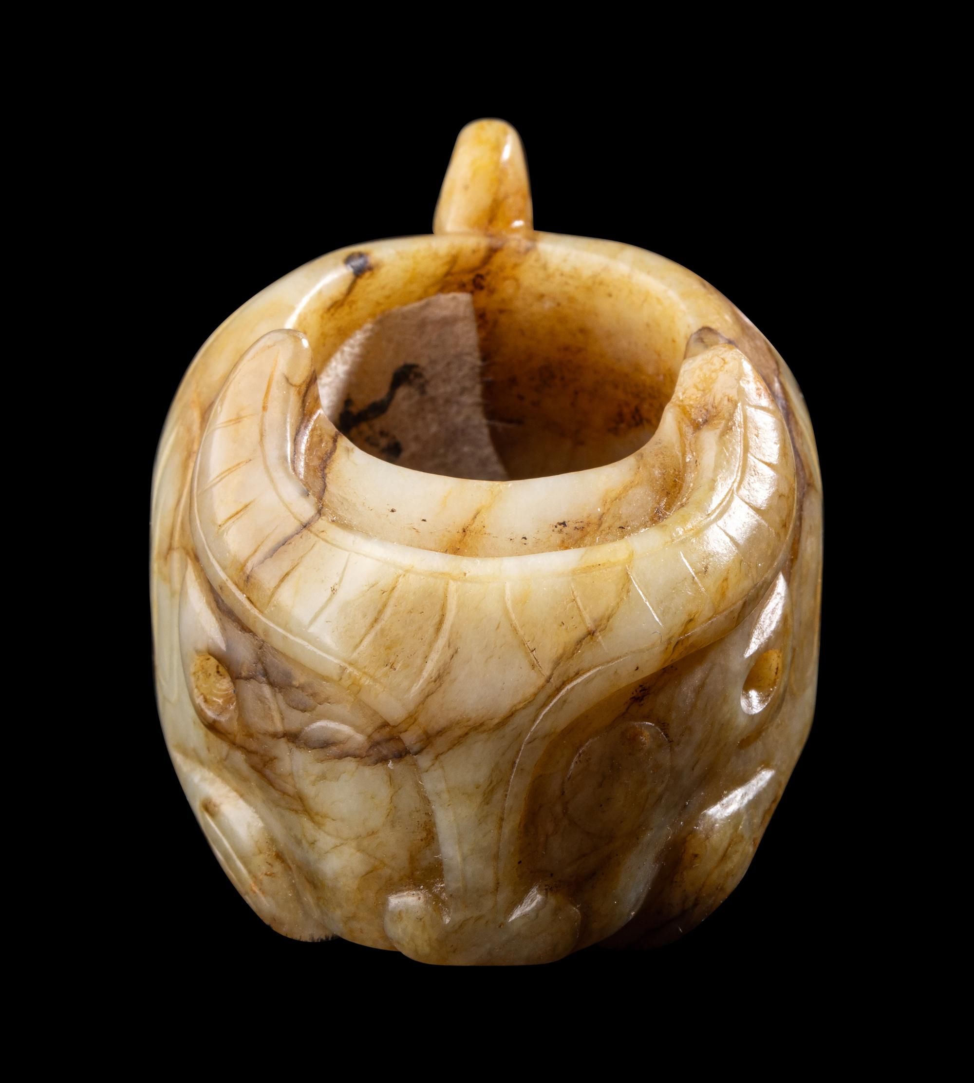 A Chinese Archaistic Yellow Jade Buffalo-Form Archer's Ring