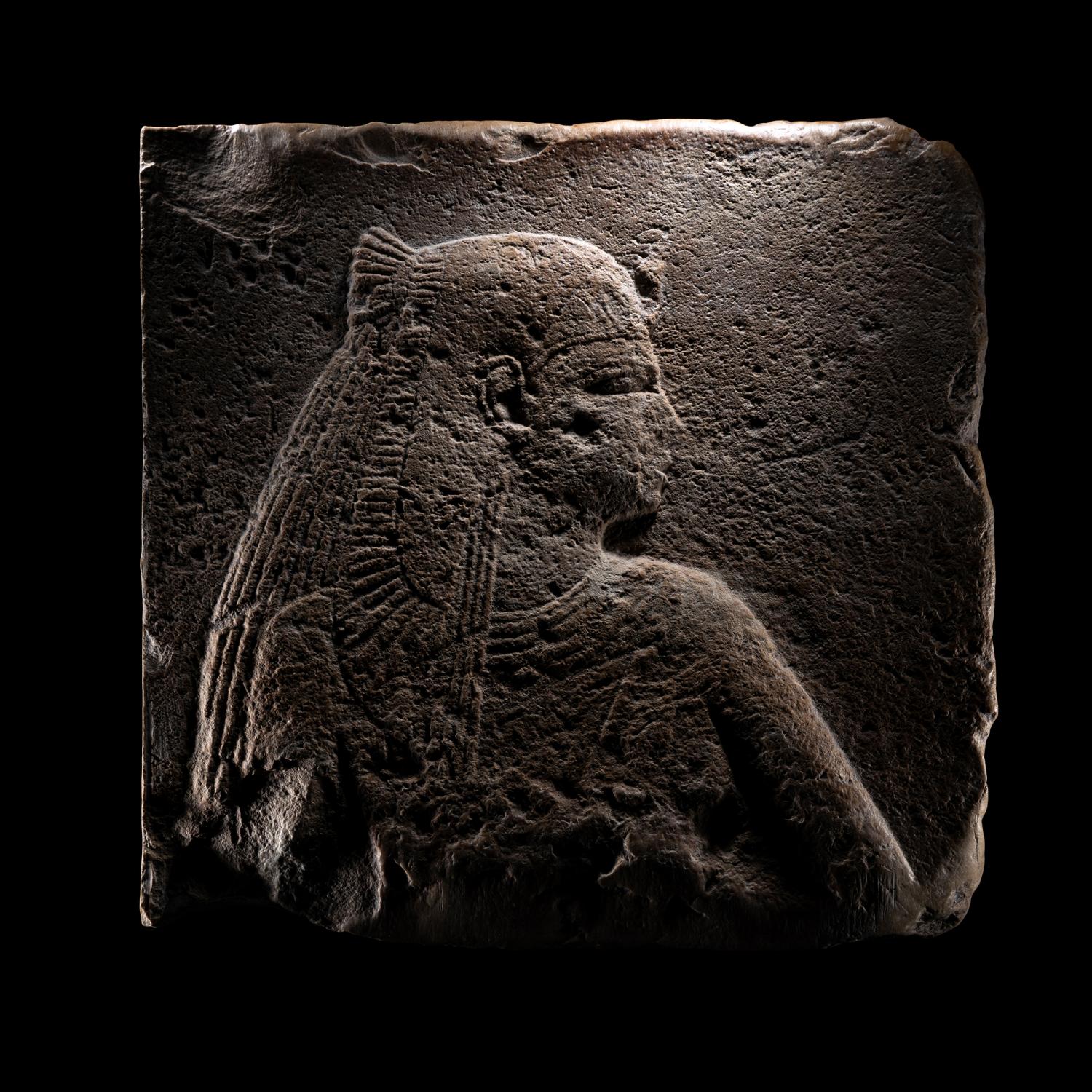 An Egyptian Stone Relief Fragment of a Female Pharaoh or Goddess