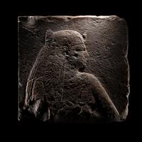 An Egyptian Stone Relief Fragment of a Female Pharaoh or Goddess