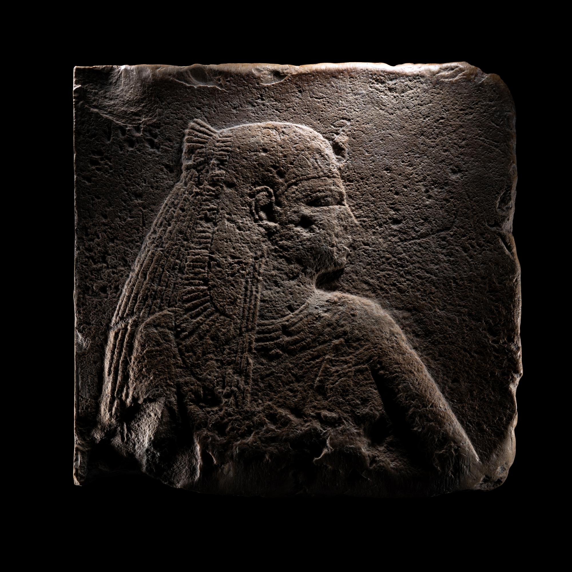 An Egyptian Stone Relief Fragment of a Female Pharaoh or Goddess