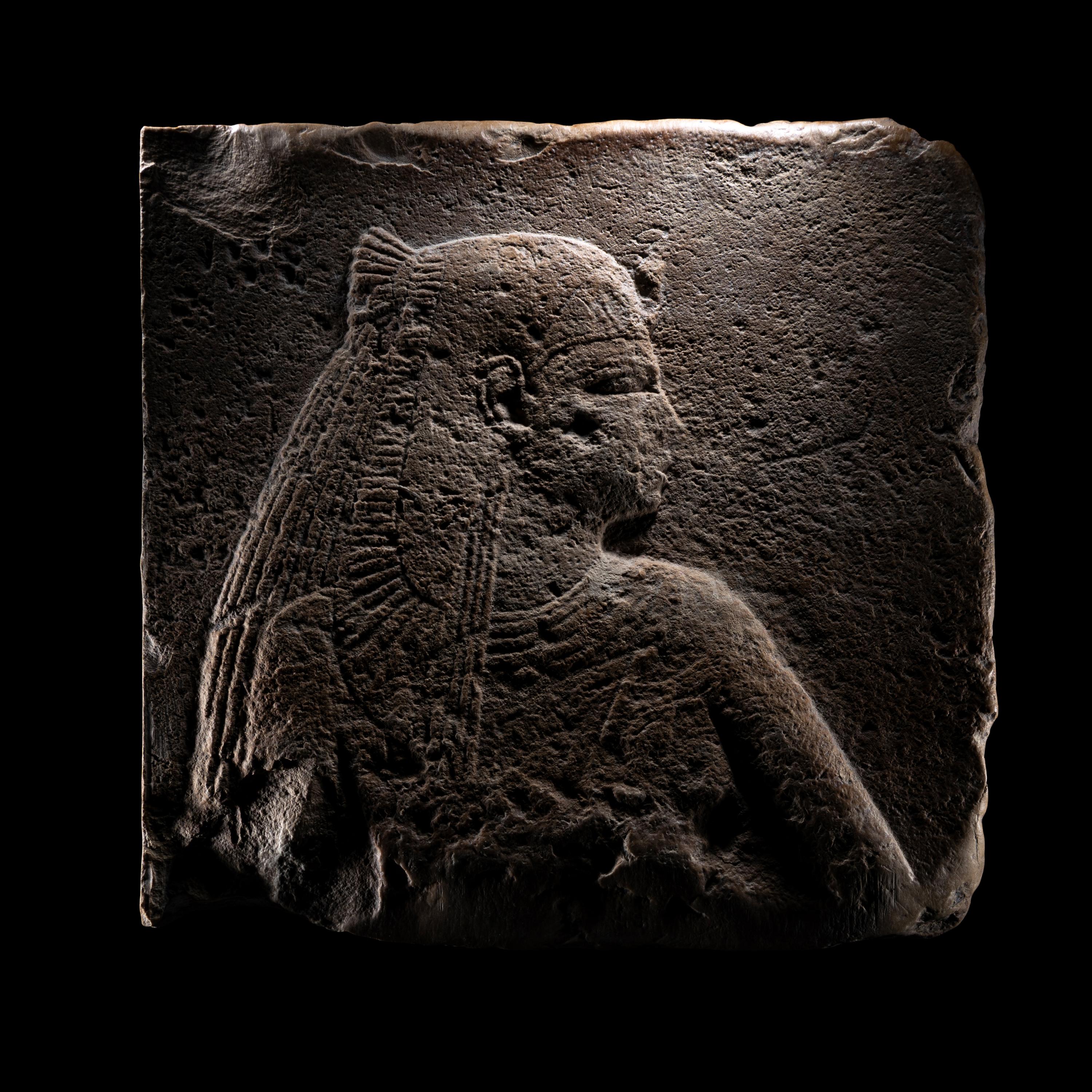 An Egyptian Stone Relief Fragment of a Female Pharaoh or Goddess