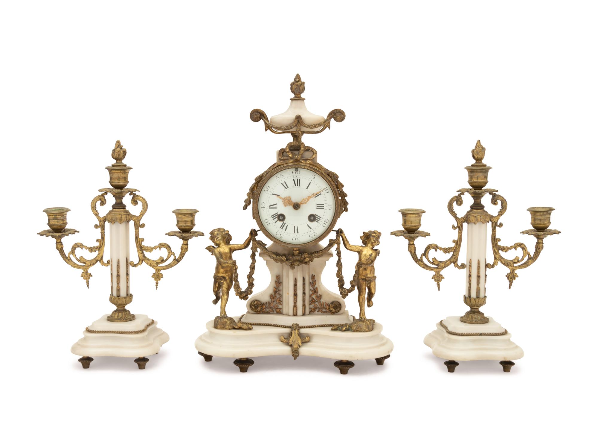 A Louis XVI Style Gilt Metal Mounted Marble Clock Garniture