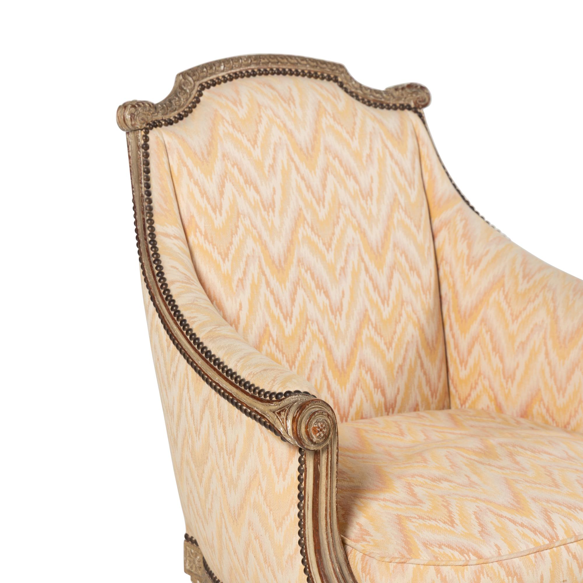 A Pair of Louis XVI Style Carved and Grey-Painted Bergères