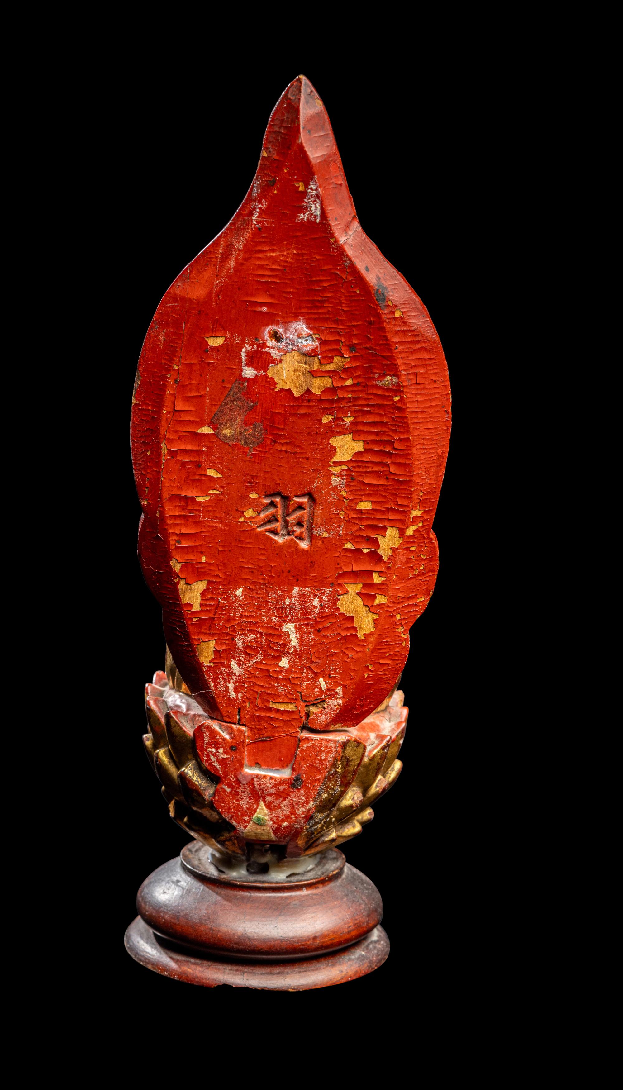 A Gilt and Red Lacquered Wood Figure of Buddha