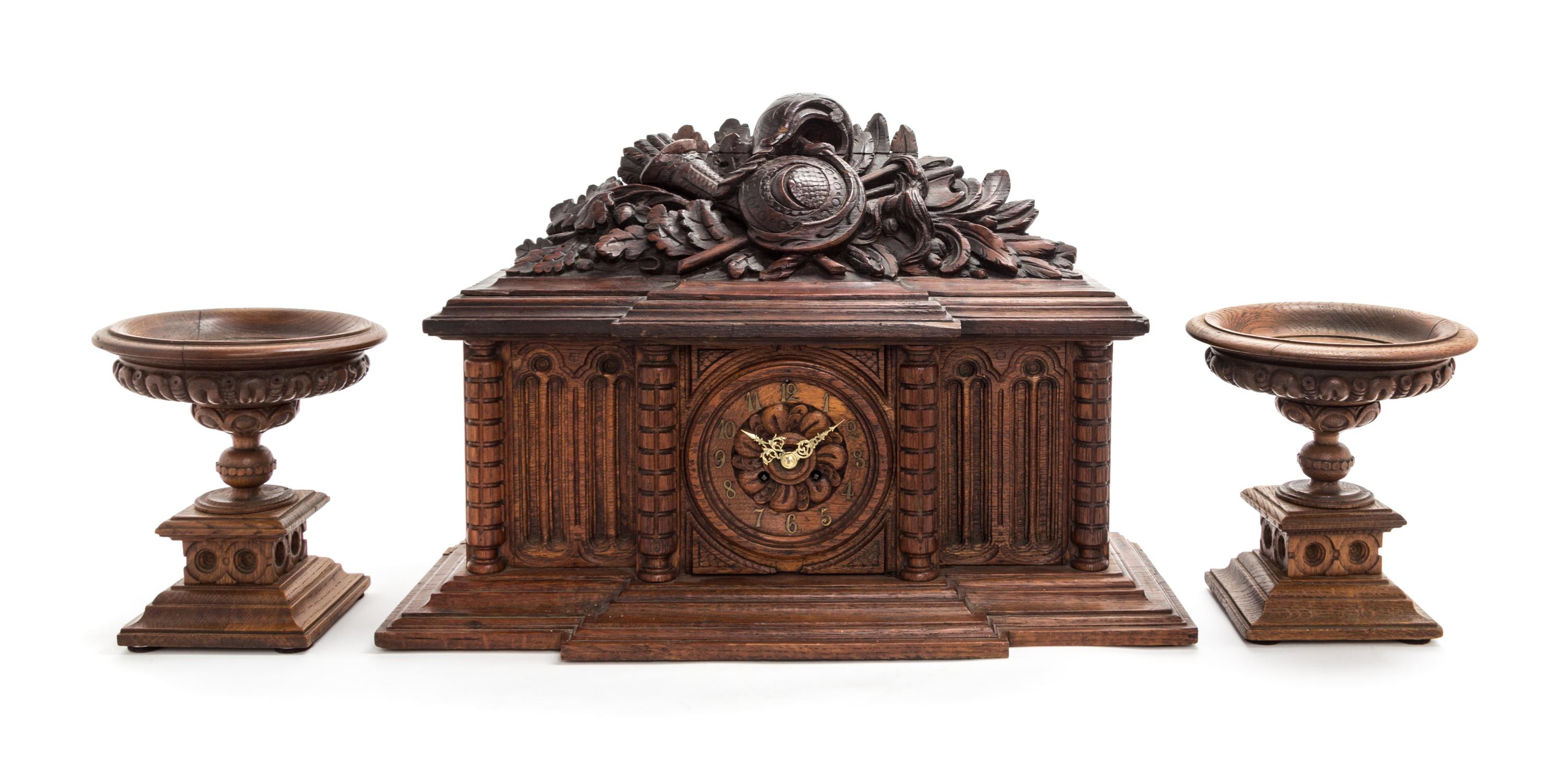 A Black Forest Style Carved Wood Clock Garniture Height overall 15 inches. — LATE 19TH CENTURY