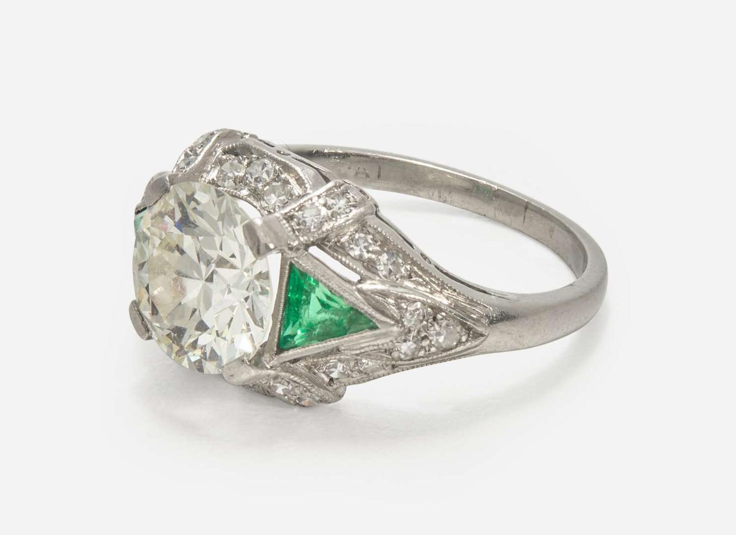 A Platinum, Diamond, and Emerald Art Deco Ring