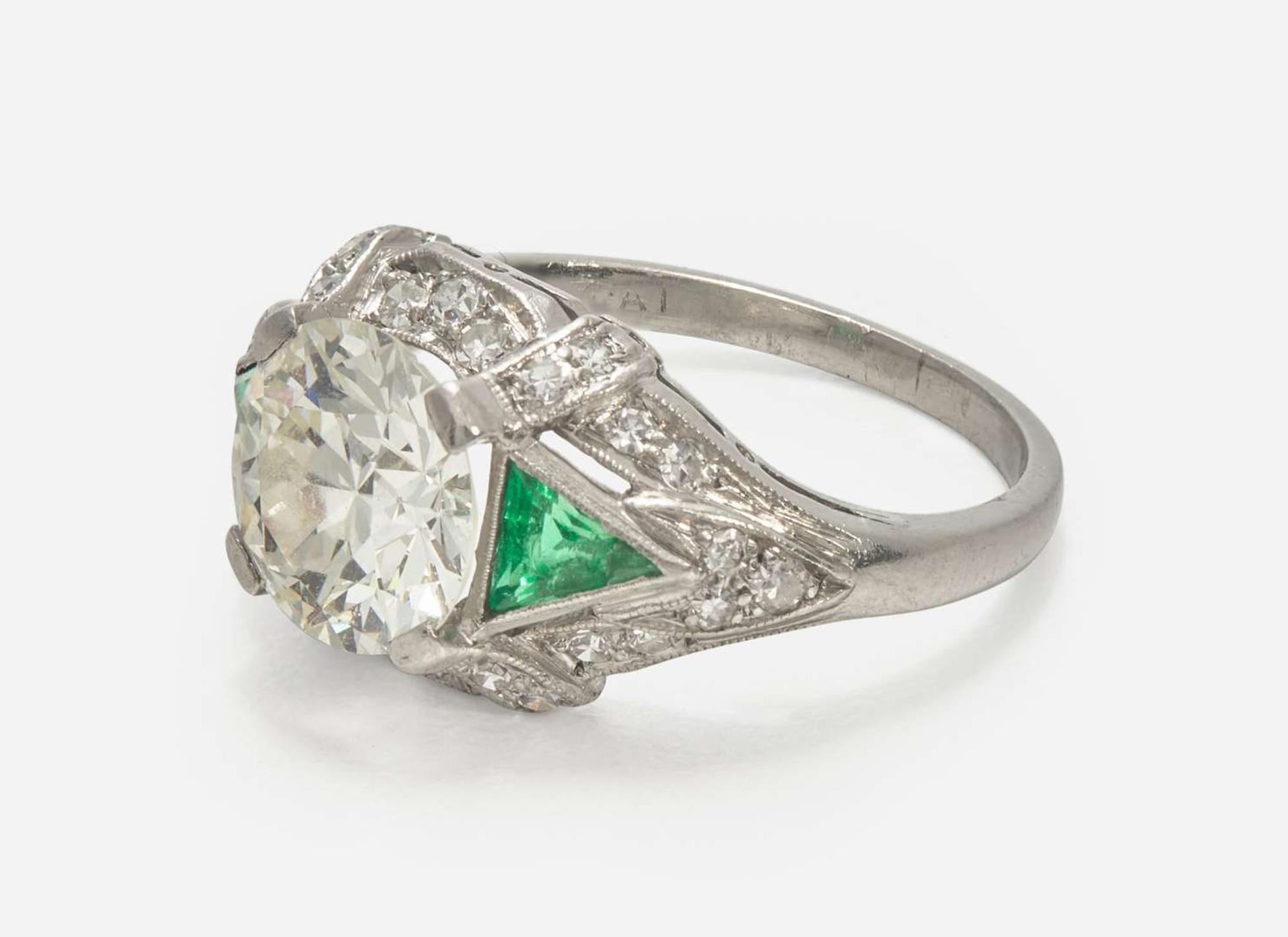 A Platinum, Diamond, and Emerald Art Deco Ring