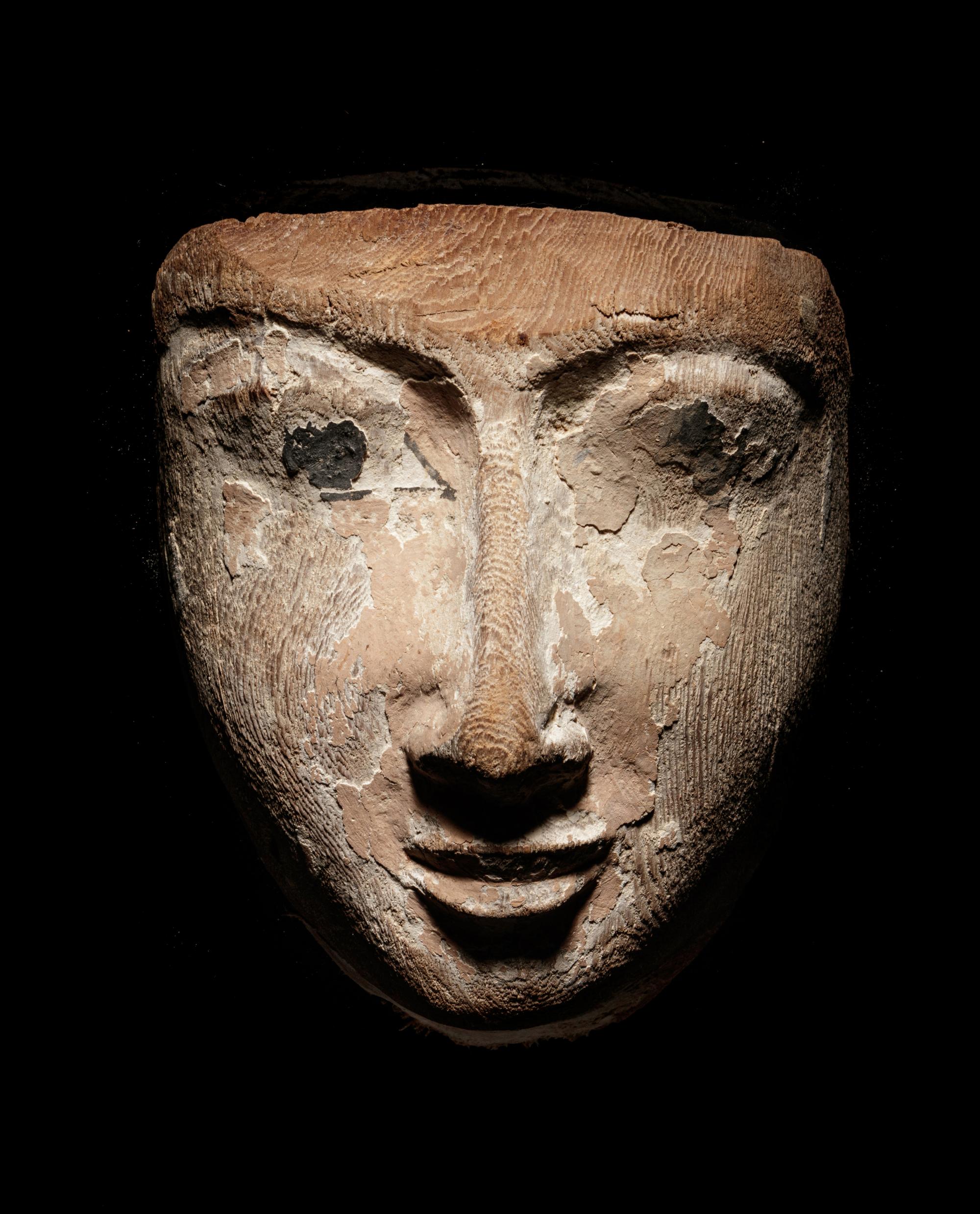 An Egyptian Wood Mummy Mask of a Woman