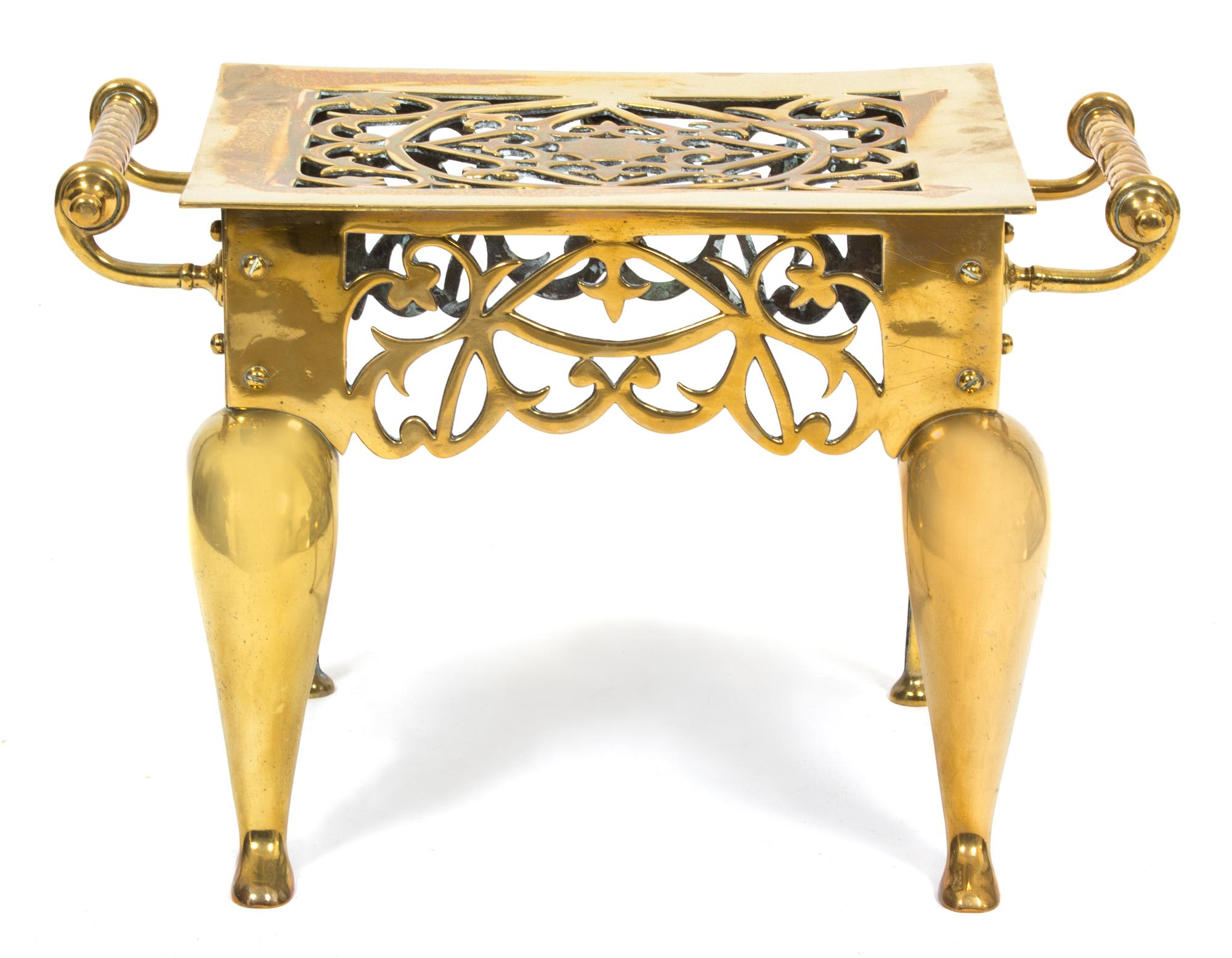 An English Pierced Brass Kettle Stand Height 11 3/4 x width 18 1/4 inches.
