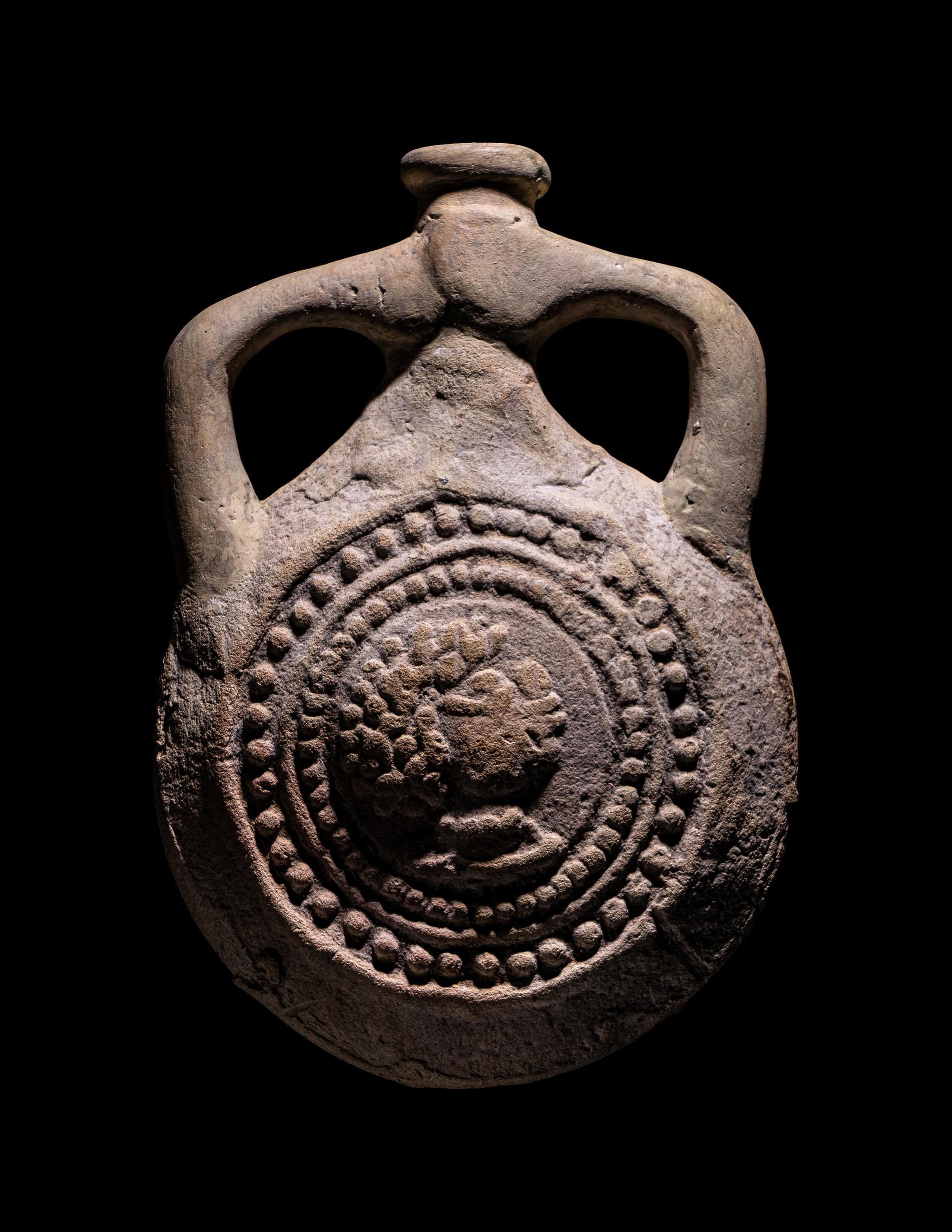 A Coptic Terracotta Pilgrim Flask with Saint Menas and Inscription