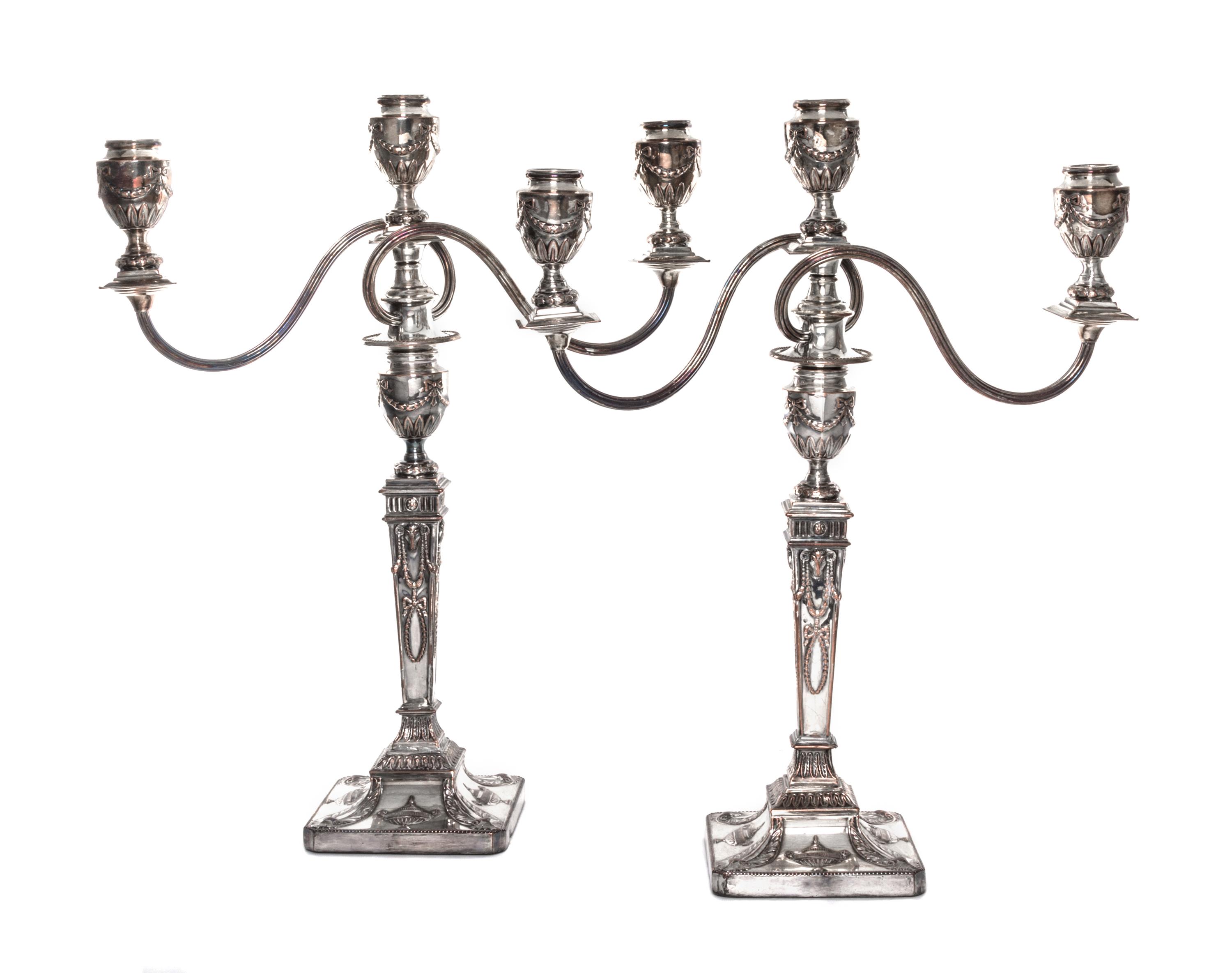 A Pair of English Neoclassical Silver-Plate Three-Light Candelabra, 19th/20th Century, each with a squared baluster form standard issui
