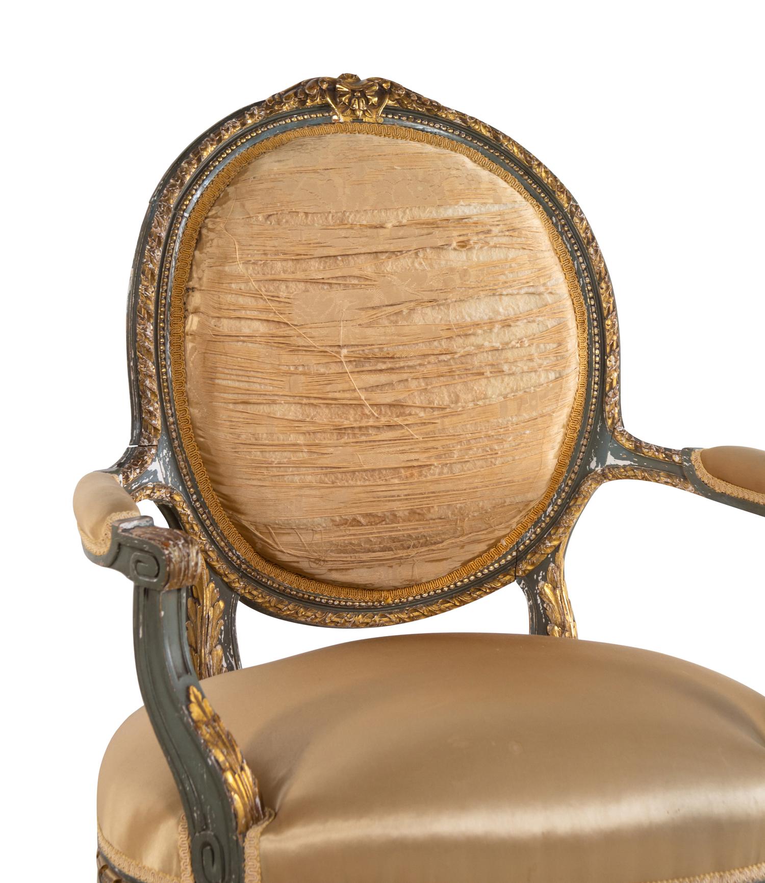 A Pair of Louis XVI Style Painted and Parcel Gilt Fauteuils