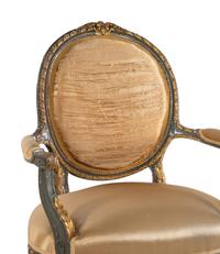 A Pair of Louis XVI Style Painted and Parcel Gilt Fauteuils