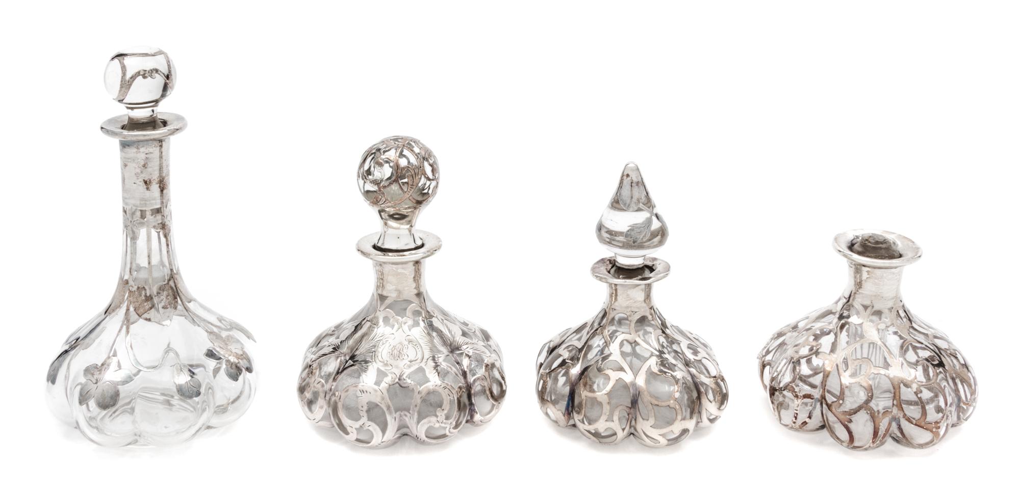 A Group of Four Silver Overlay Glass Perfume Bottles Height of tallest 6 1/2 inches.