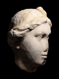 A Roman Marble Head of a Woman with Plaited Hair and Ribbon