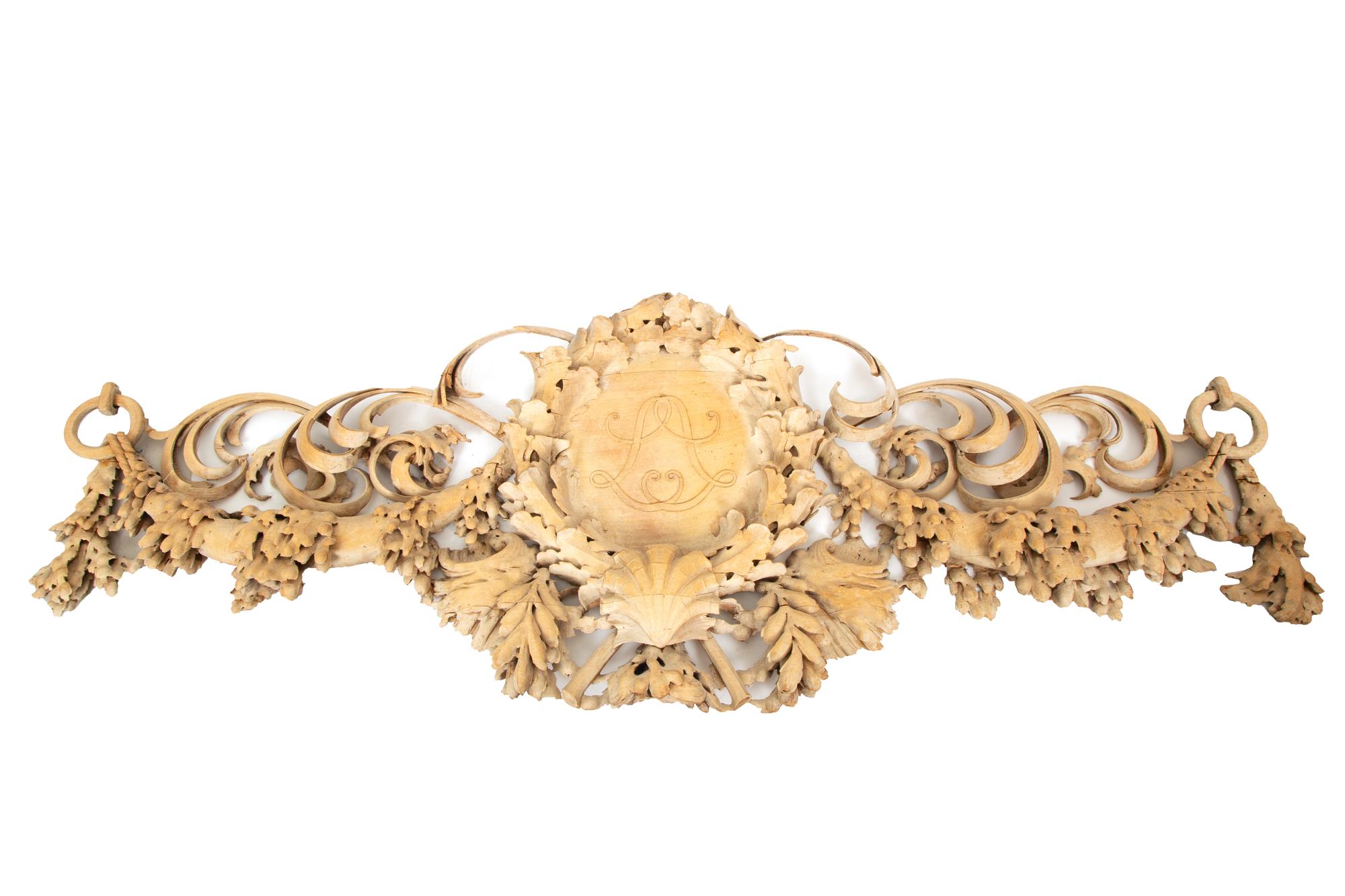 A French Carved Limewood Overdoor Panel with Scrolling Foliage, Fruit and Shells