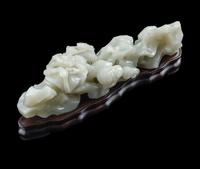 A Chinese Pale Celadon Jade ‘Lingzhi and Rockwork’ Brush Rest, 20th Century — 近代 青白玉靈芝筆架