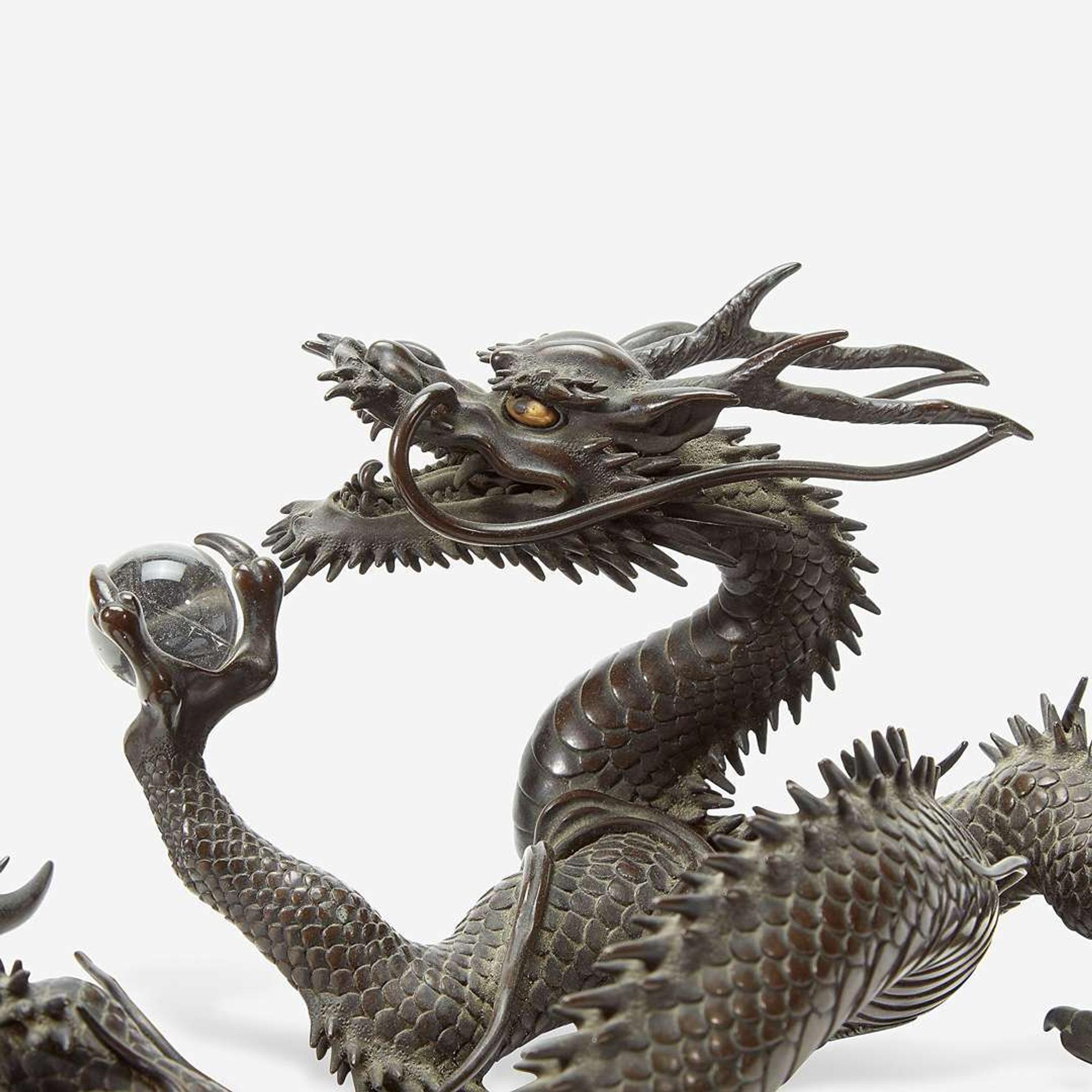 A Japanese patinated bronze dragon and rock crystal sphere Meiji period