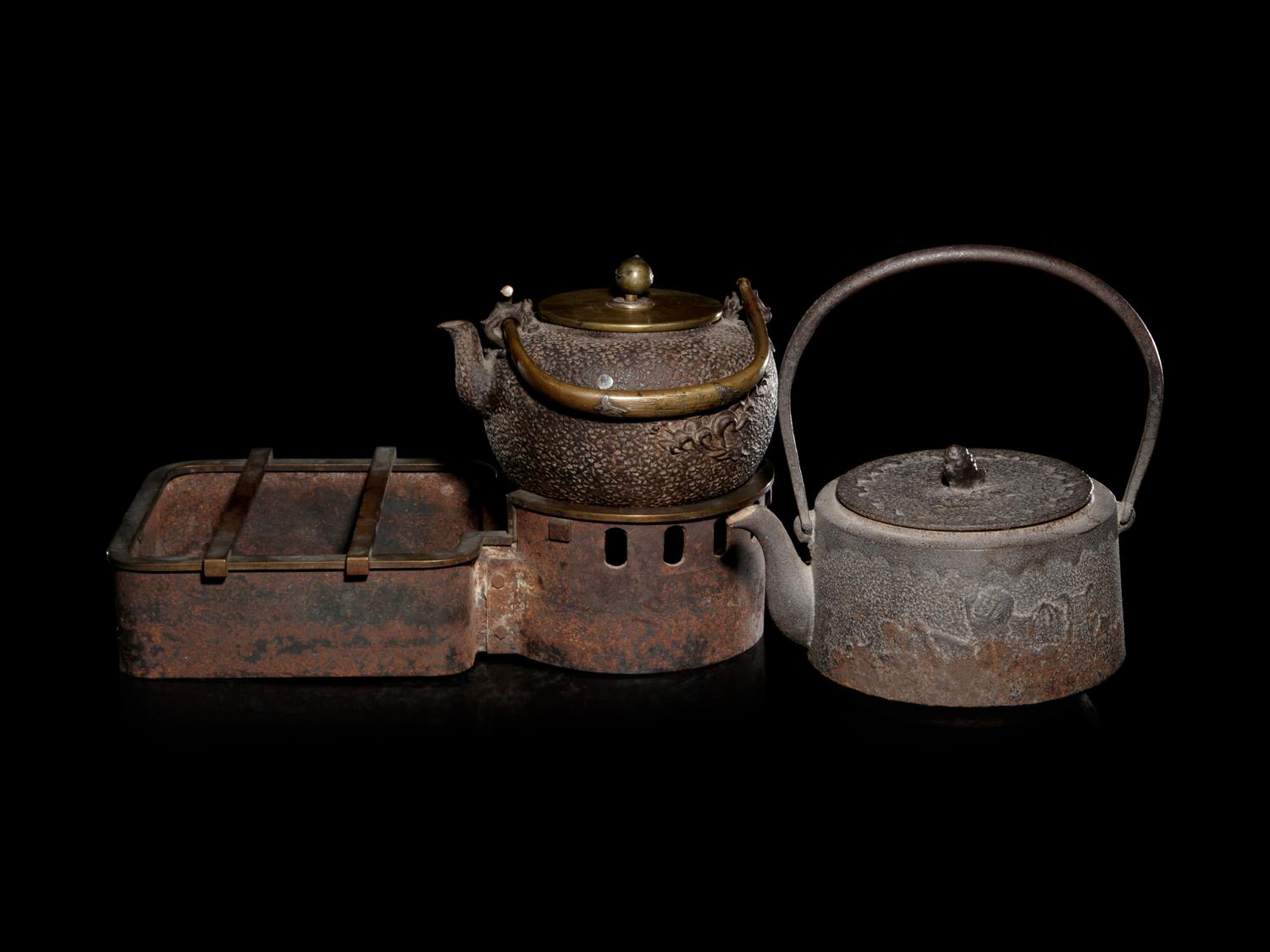 Seven Japanese Cast Iron Teapots, Tetsubin, and Burner