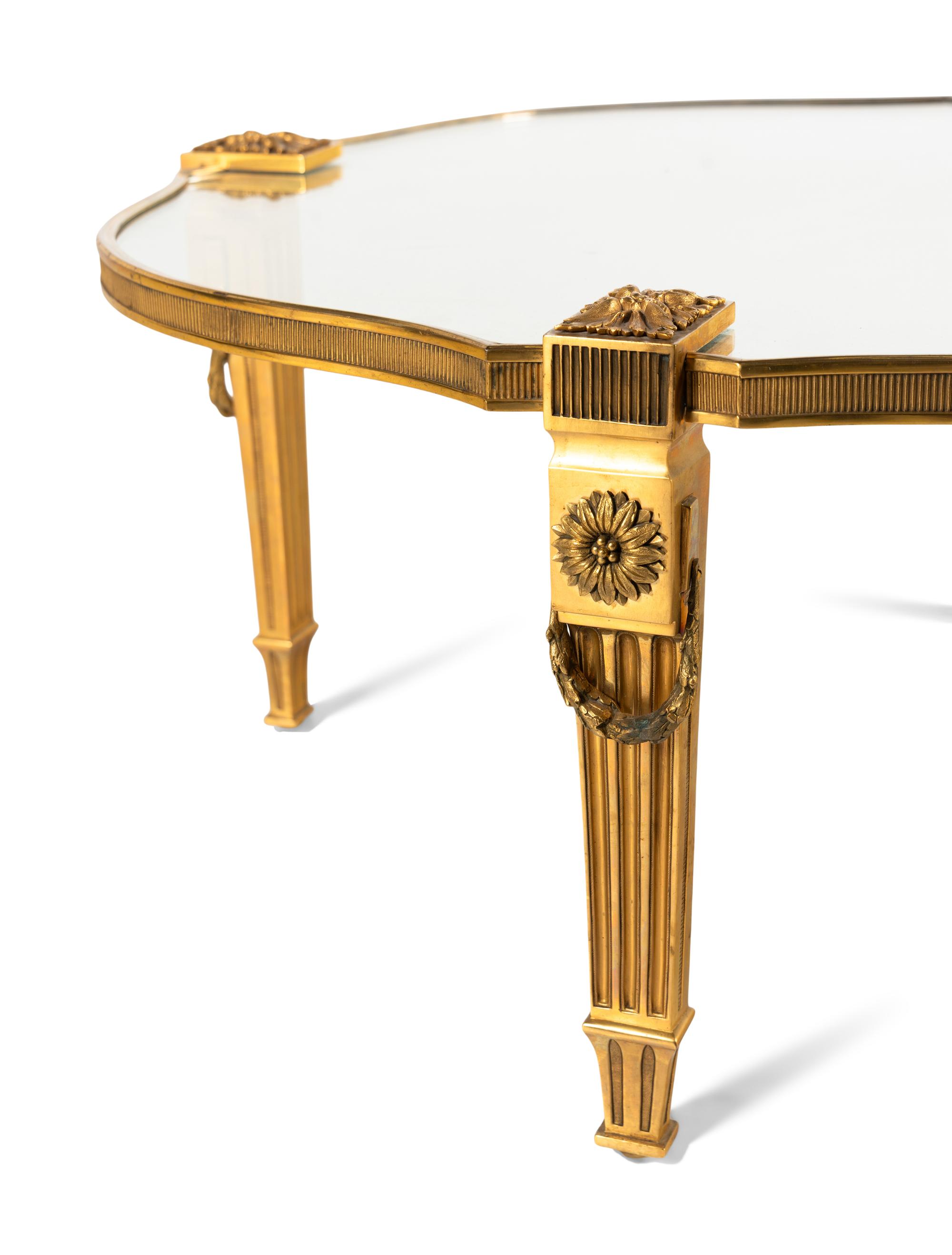 A Gilt Bronze and Glass Cocktail Table