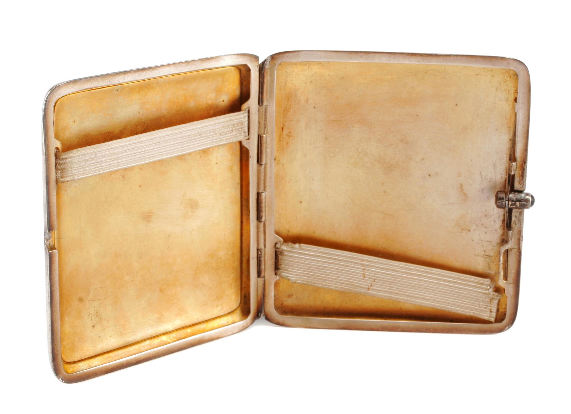 An Enameled Silver Cigarette Case, Late 19th/Early 20th Century, the lid enameled to show a seated nude before a dressing table.