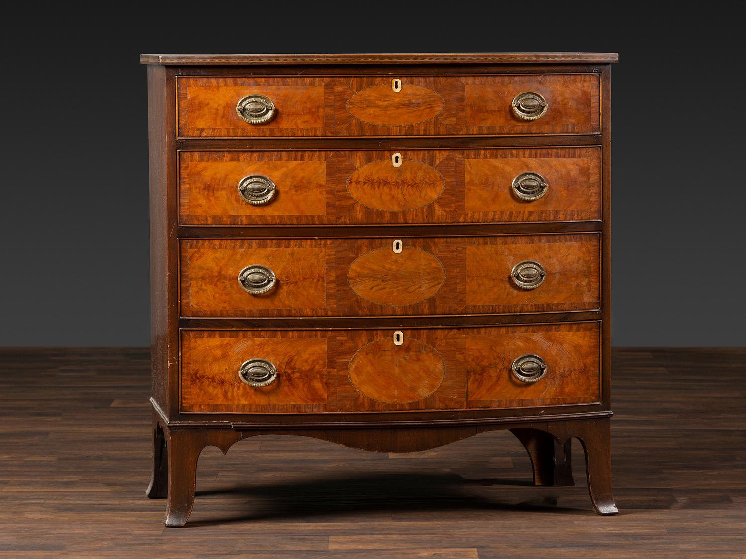 A Federal Inlaid and Figured Mahogany Bow-Front Chest of Drawers